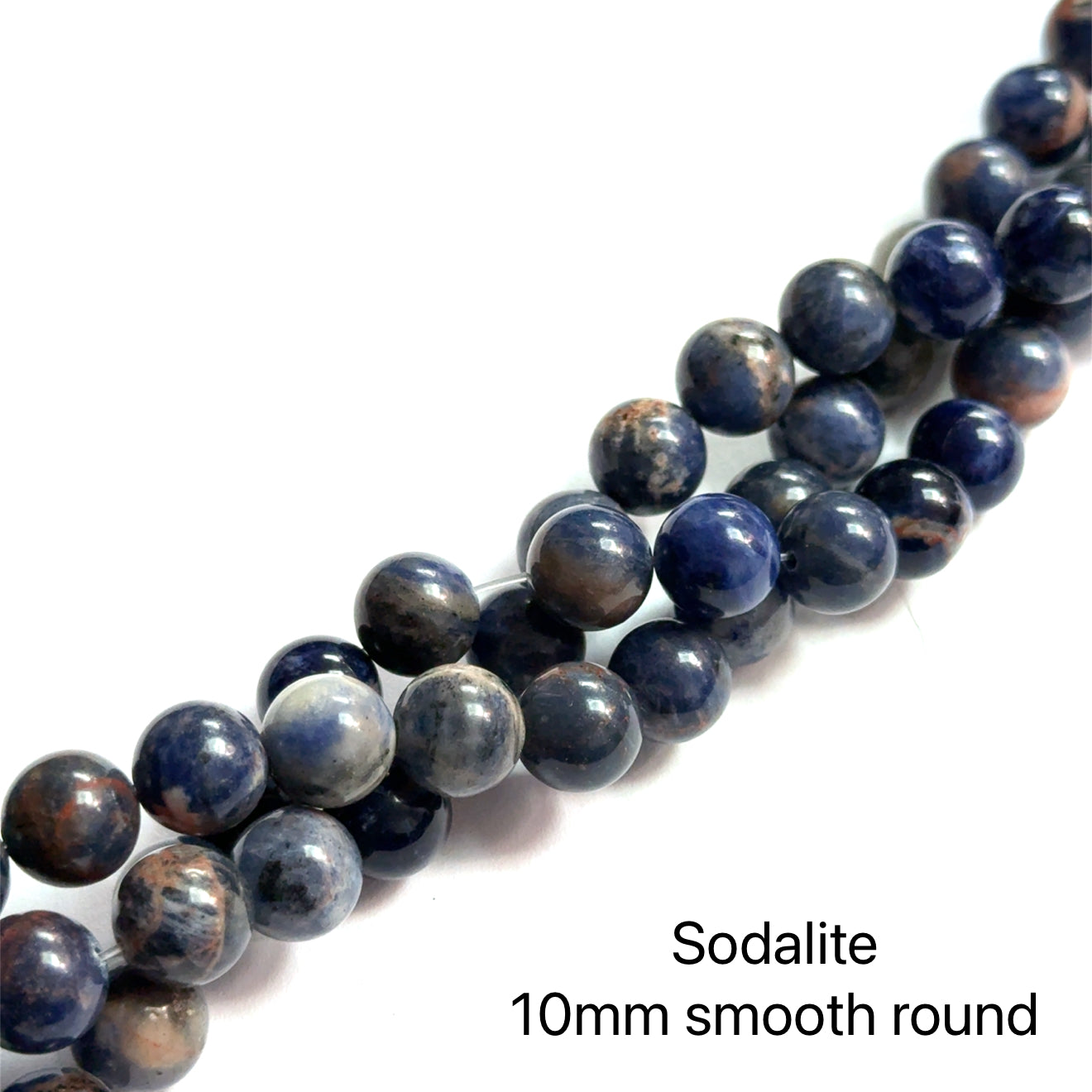 10mm  Sodalite smooth round gemstone strand on a white background, front close up  overview.