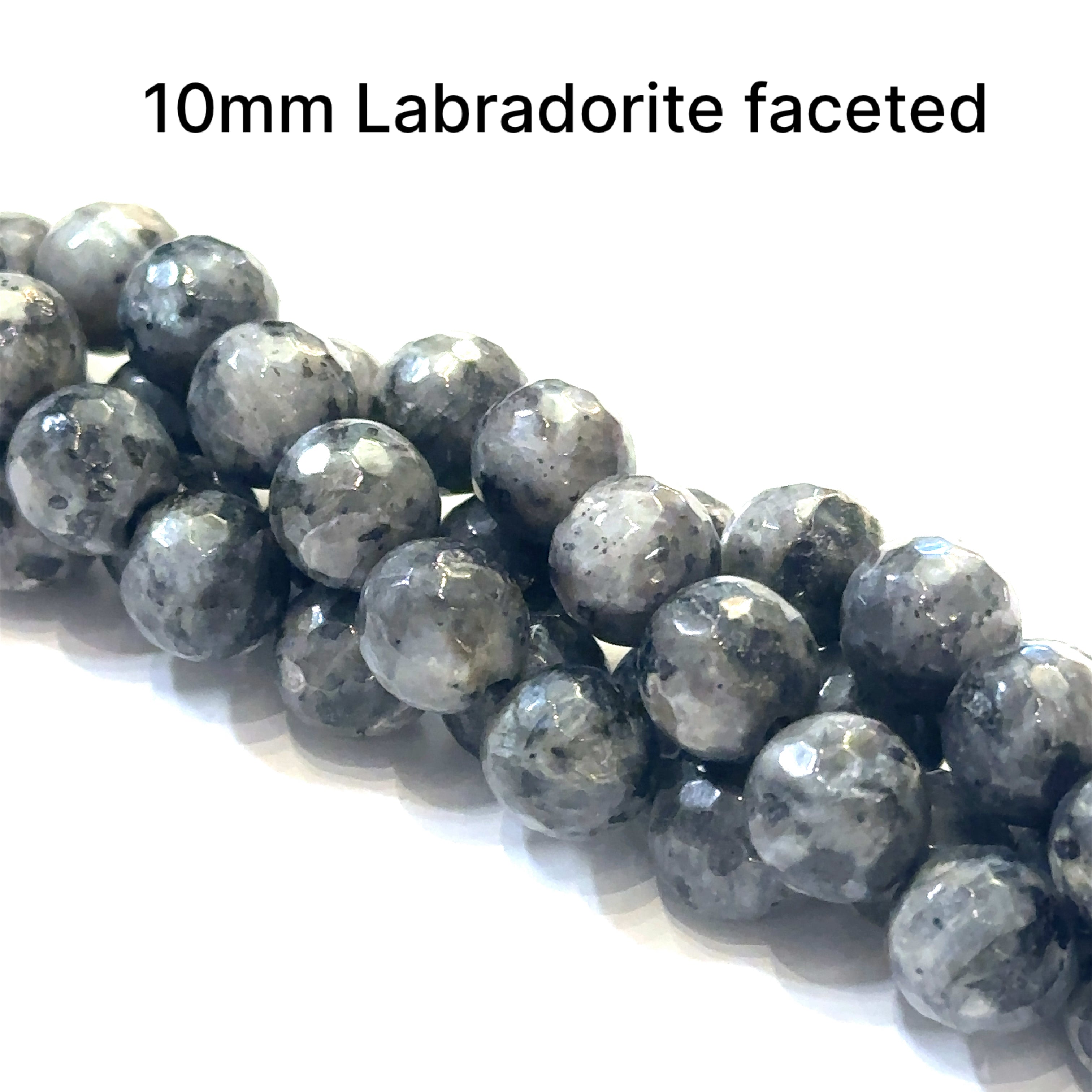 10mm faceted round black Labradorite beads on a white background, front overview.