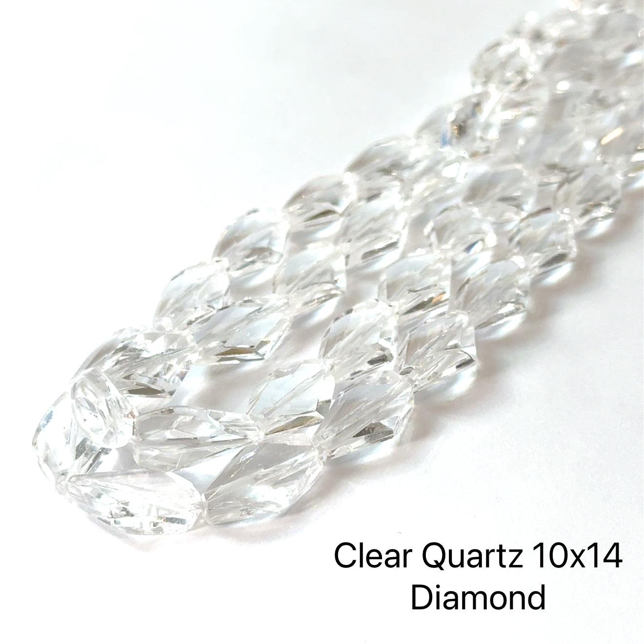 10x14mm Clear Quartz faceted diamonds gemstone strand on a white background, overview. 