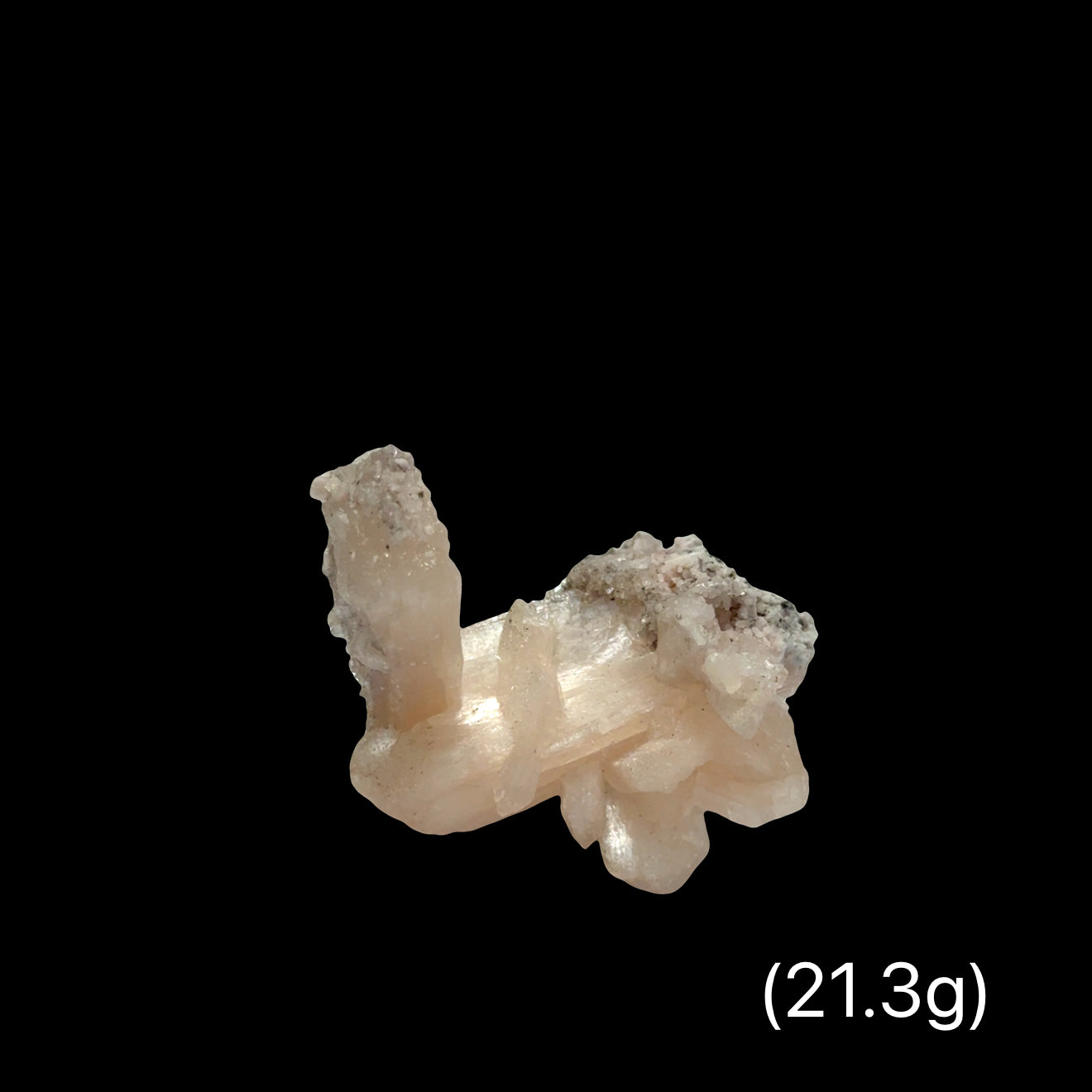 #15 Peach Stilbite on a Black background, front view.