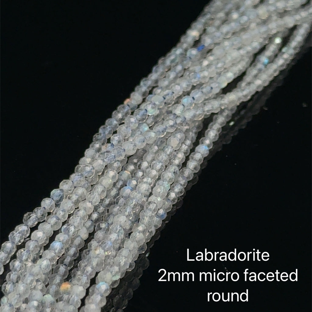 2mm micro faceted round Labradorite beads on a white background, front overview. 