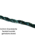 2x3mm Grandiderite faceted roundel gemstone strand on a white background, on a white background, front view.