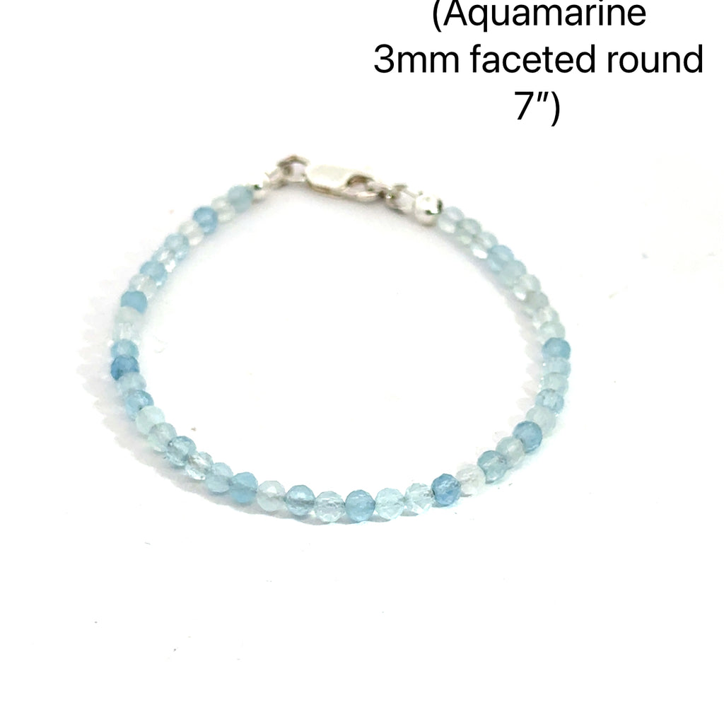 3mm micro faceted round Aquamarine gemstone beaded bracelet with sterling silver lobster claw clasp size 7'' showing pale blue translucent color on a white background front overview. 