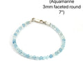 3mm micro faceted round Aquamarine gemstone beaded bracelet with sterling silver lobster claw clasp size 7'' showing pale blue translucent color on a white background front overview. 