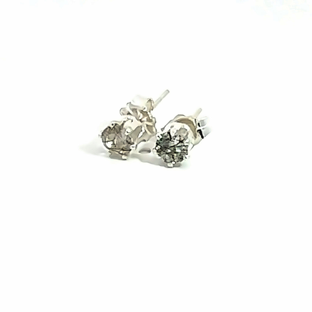 4mm faceted Rutilated Quartz stud earrings in sterling silver basket setting on a white background close up left front angle overview.