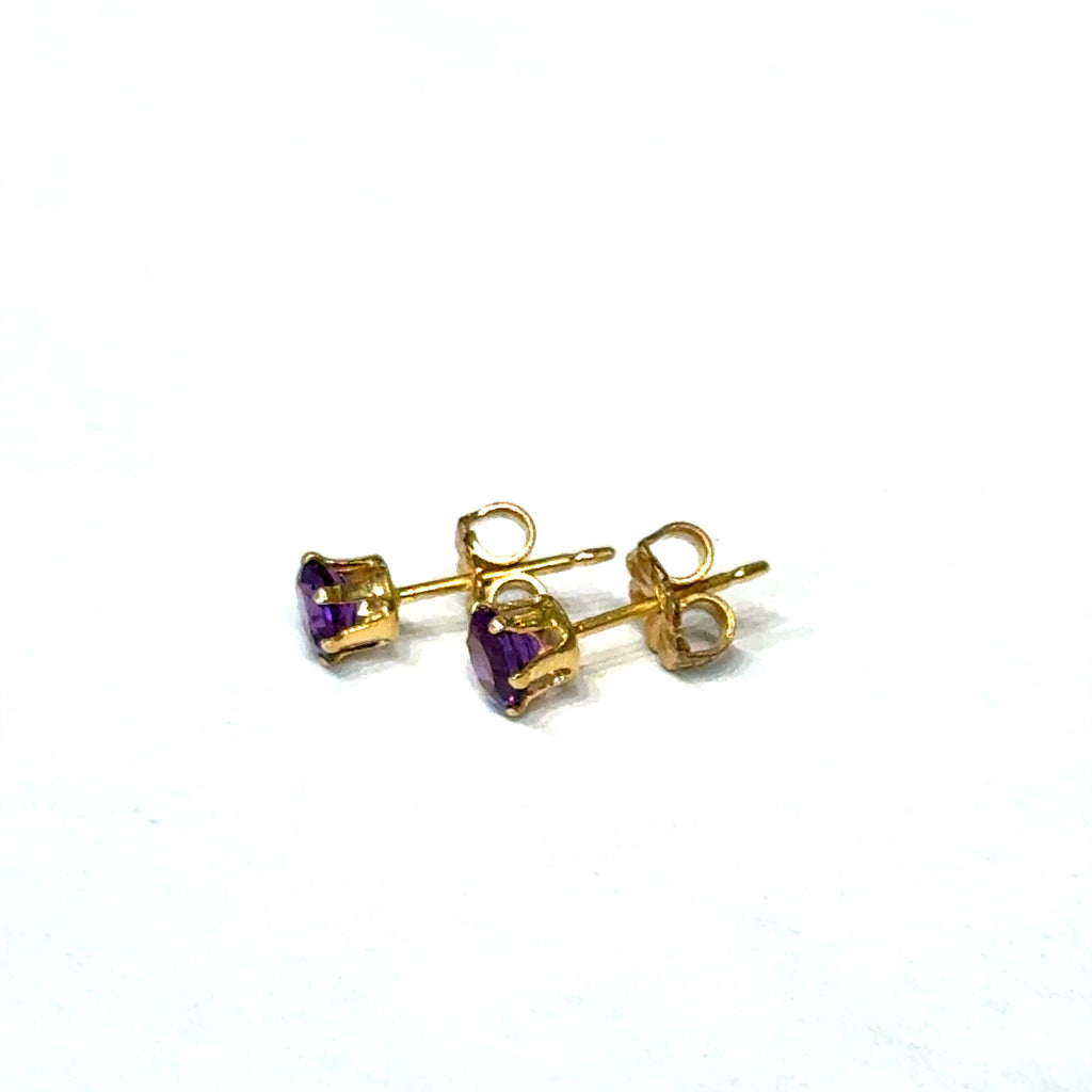 4mm faceted round Amethyst stud earrings in gold filled 6-prong setting on a white background front left angle overview.
