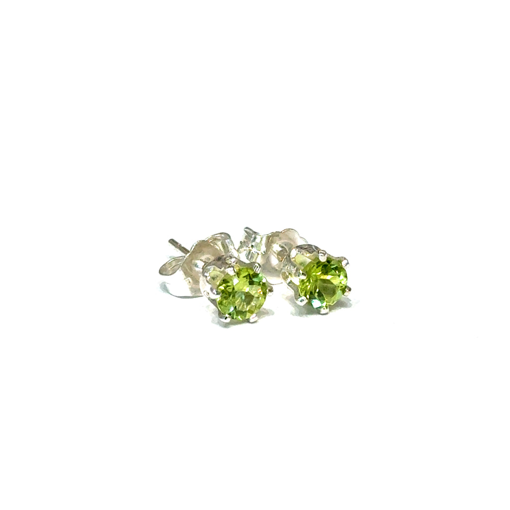 4mm round faceted Peridot stud earrings in sterling silver double prong setting on a white background slight right angle front overview