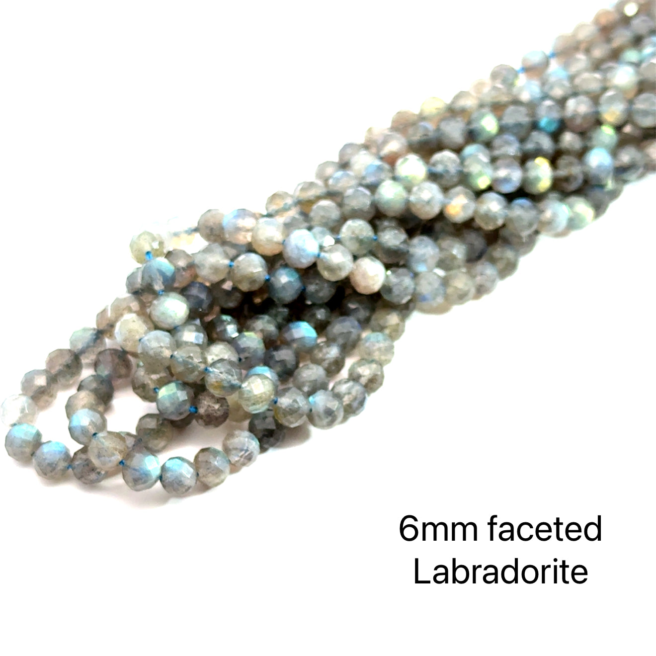6mm faceted round Labradorite beads on a white background, front overview. 