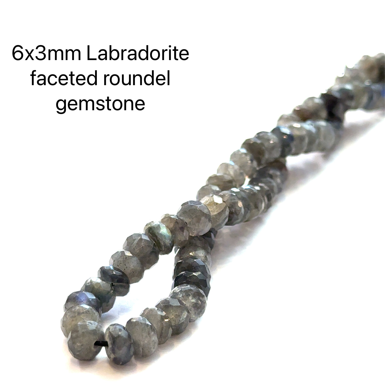6x3mm faceted roundel Labradorite beads on a white background, front overview. 
