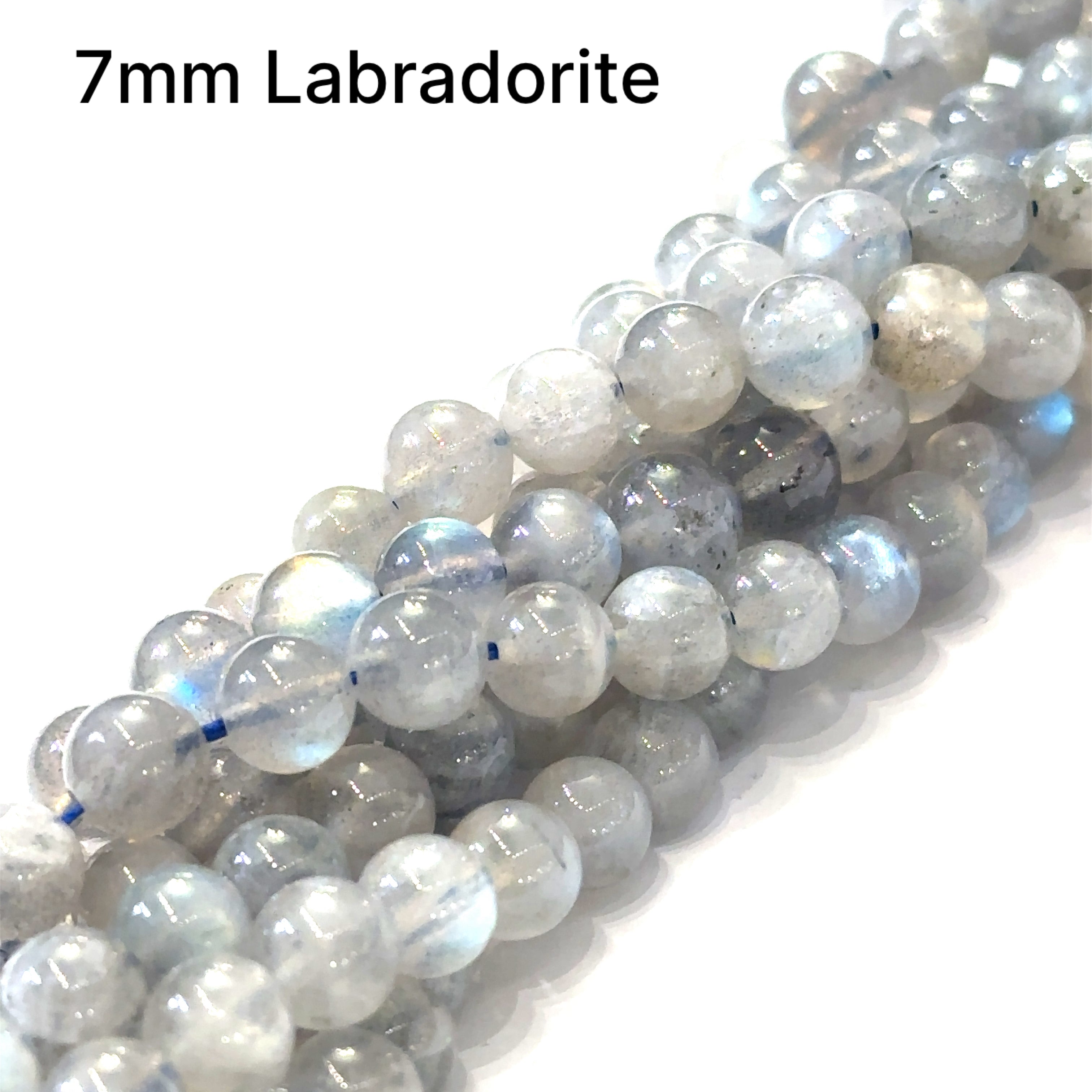 7mm smooth round Labradorite beads on a white background, front overview.
