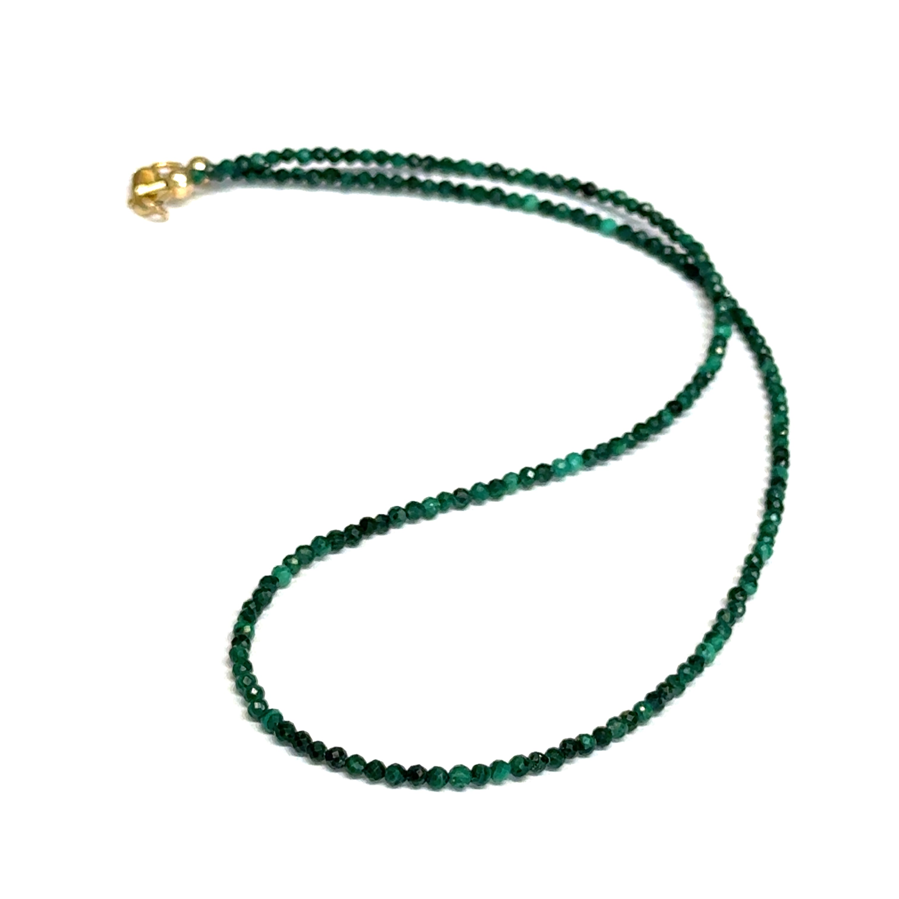 A 2mm faceted round malachite gemstone necklace with a gold-filled lobster claw clasp on a white background, long overview.