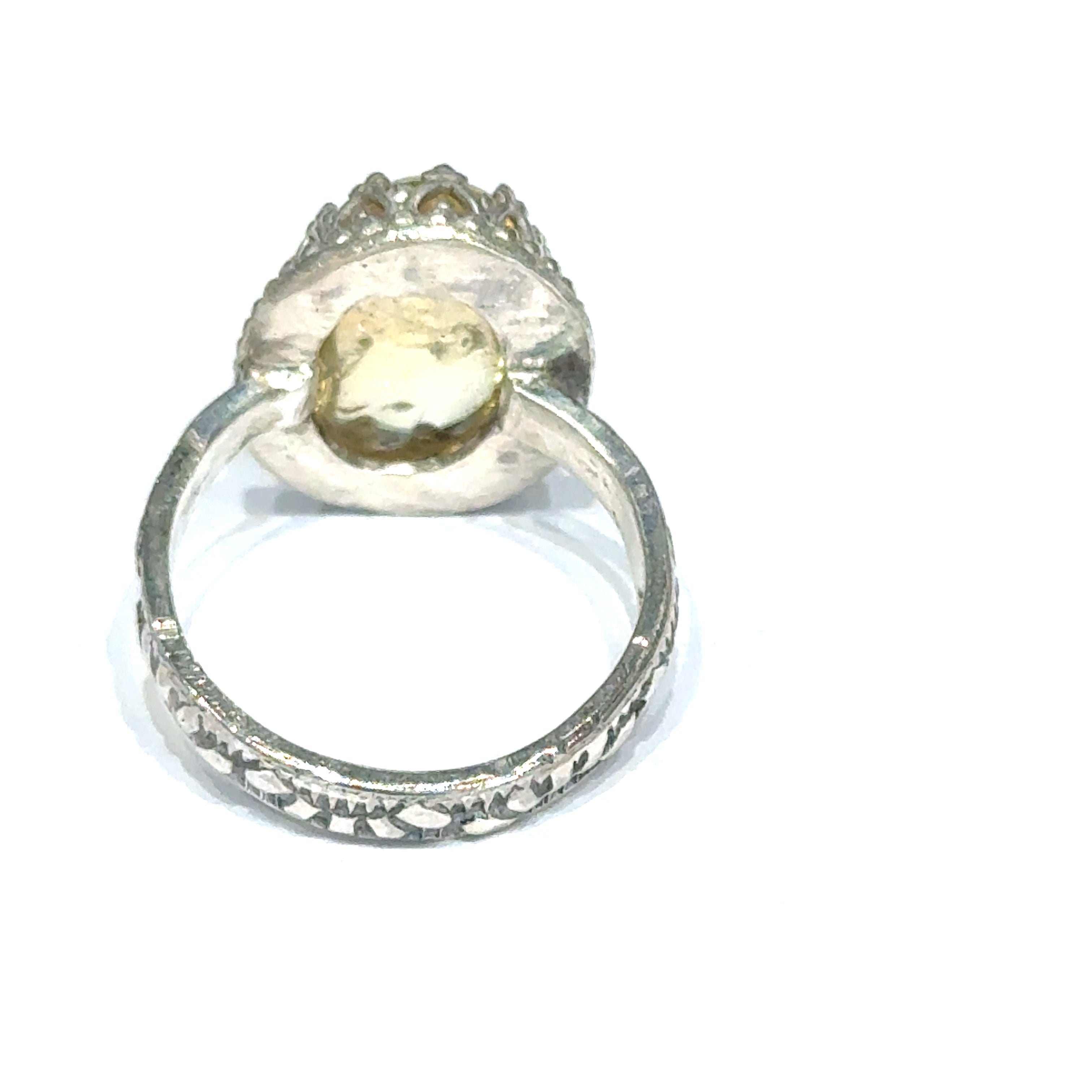 A Citrine Gemstone ring in sterling silver a vintage style on a white background back, close up view.