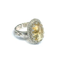 A Citrine Gemstone ring in sterling silver a vintage style on a white background right side, close up view.