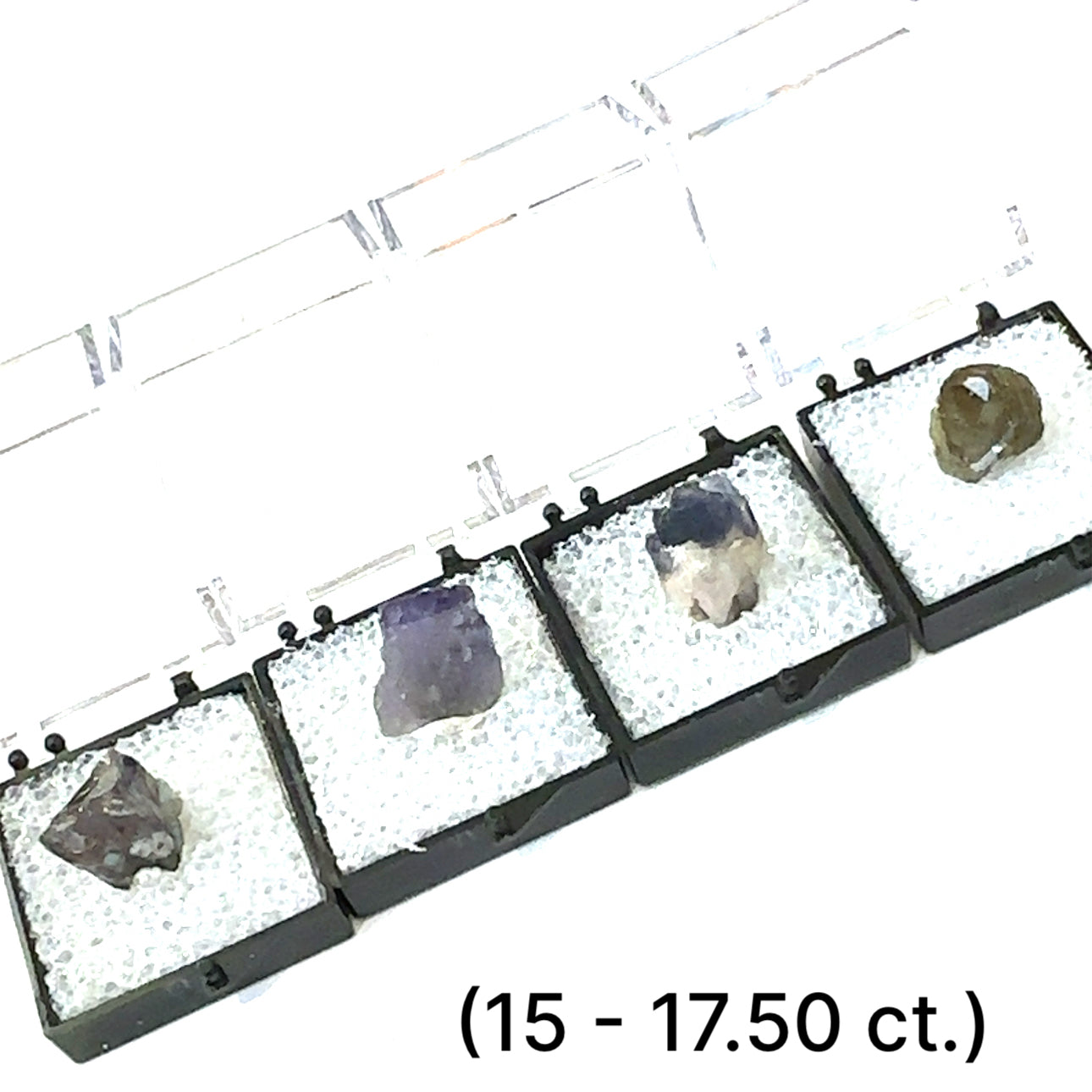 A Close-up of Tanzanite crystal in perky boxes showing deep violet-blue hues, on a white background, front view. size (15.-17.50ct) gem grade.