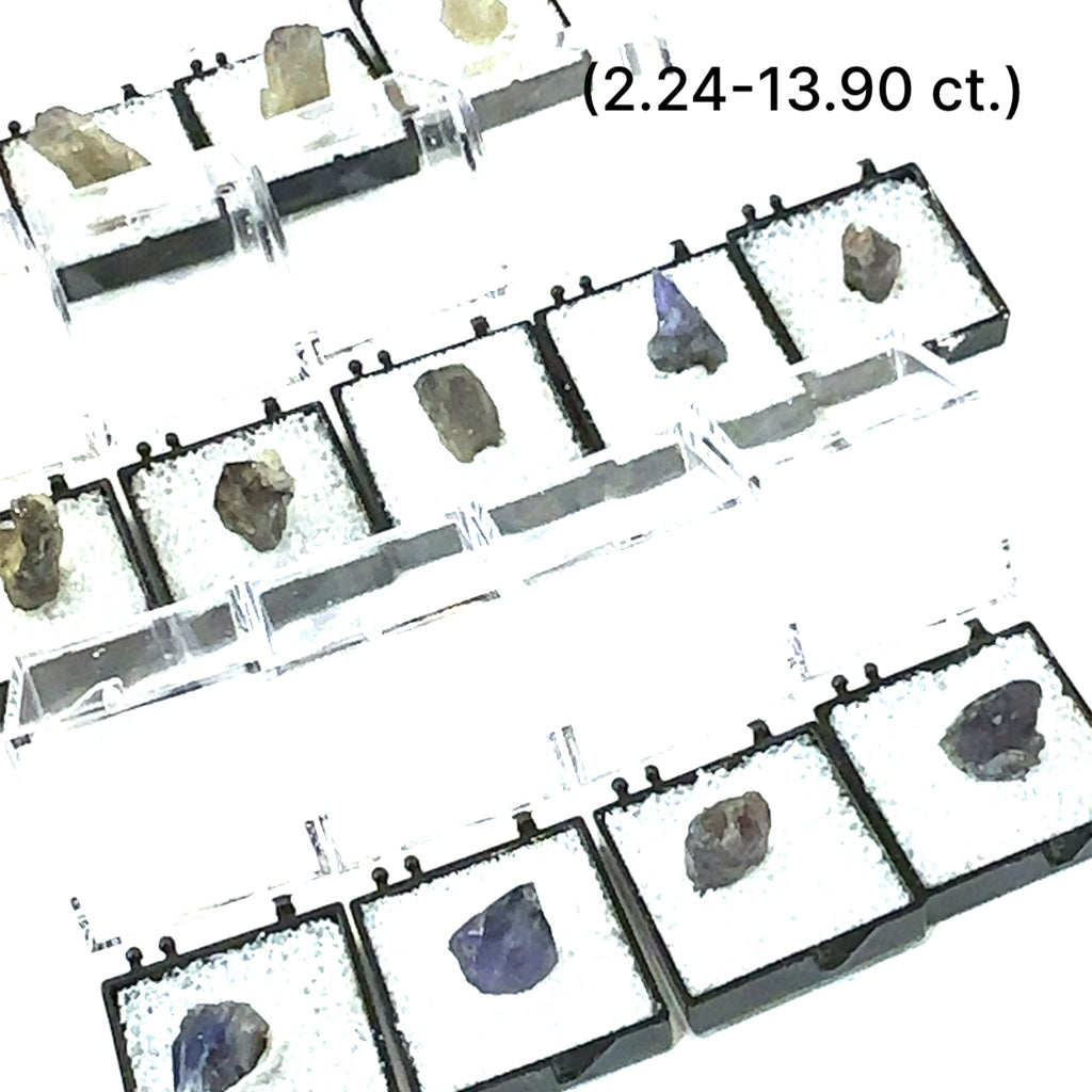 A Close-up of Tanzanite crystal in perky boxes showing deep violet-blue hues, on a white background, front view. size (2.24-13.90ct) gem grade.