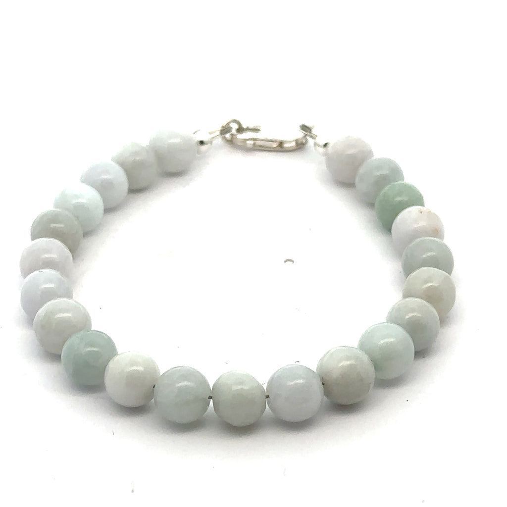 A Close-up of a 8mm polished Burma jade beads showing natural green color and smooth finish on a white background, front close-up overview.