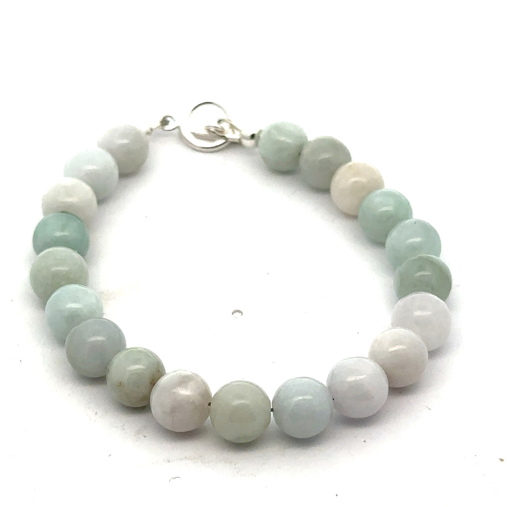 A Close-up of a 8mm polished Burma jade beads showing natural green color and smooth finish on a white background, front view.