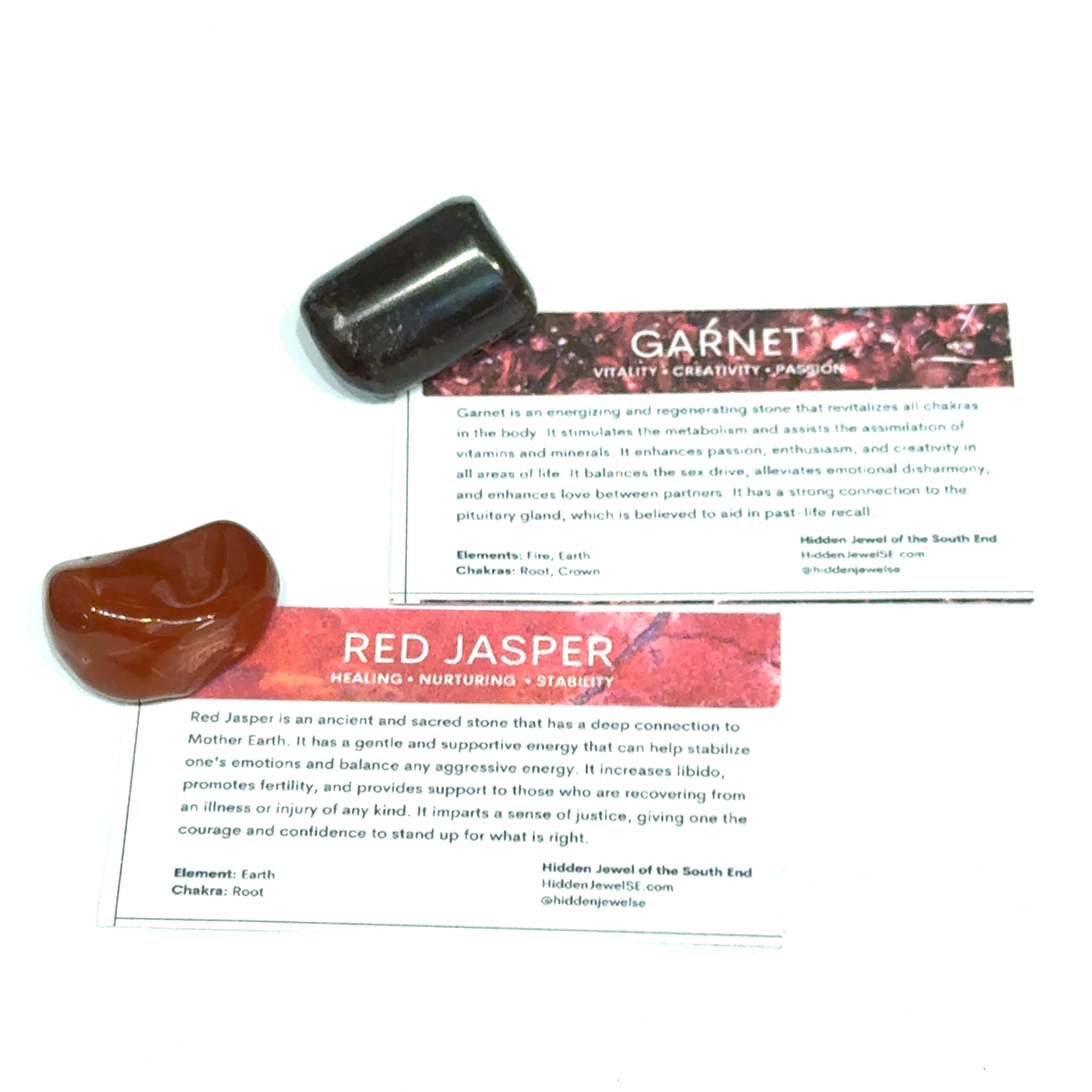 A Garnet and a red Jasper gemstone with the informational card on a white background, front view.