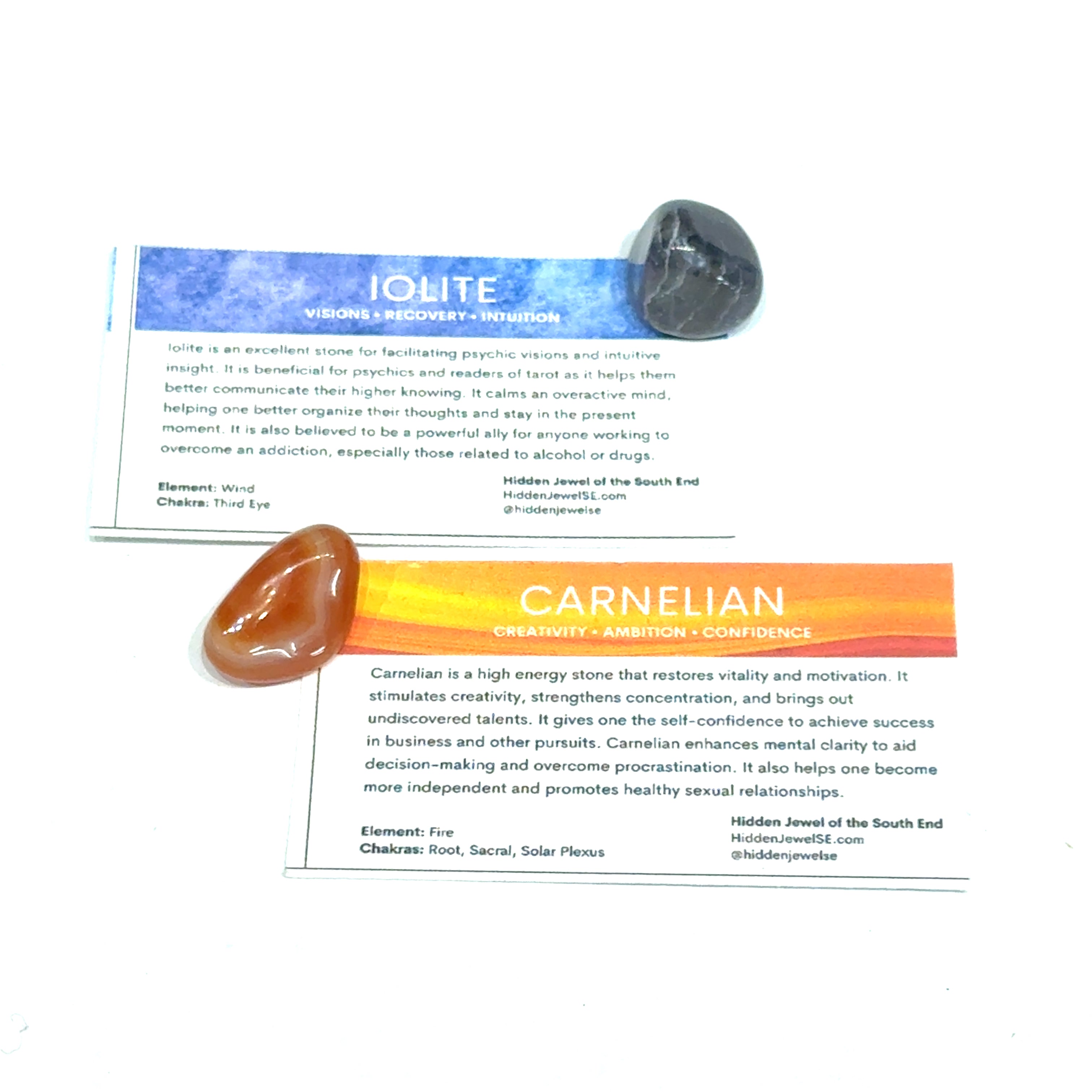 A Iolite and a Carnelian gemstone with the informational card on a white background, front view.