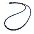 A Lapis Lazuli gemstone beaded necklace on a white background long overview, front overview. 