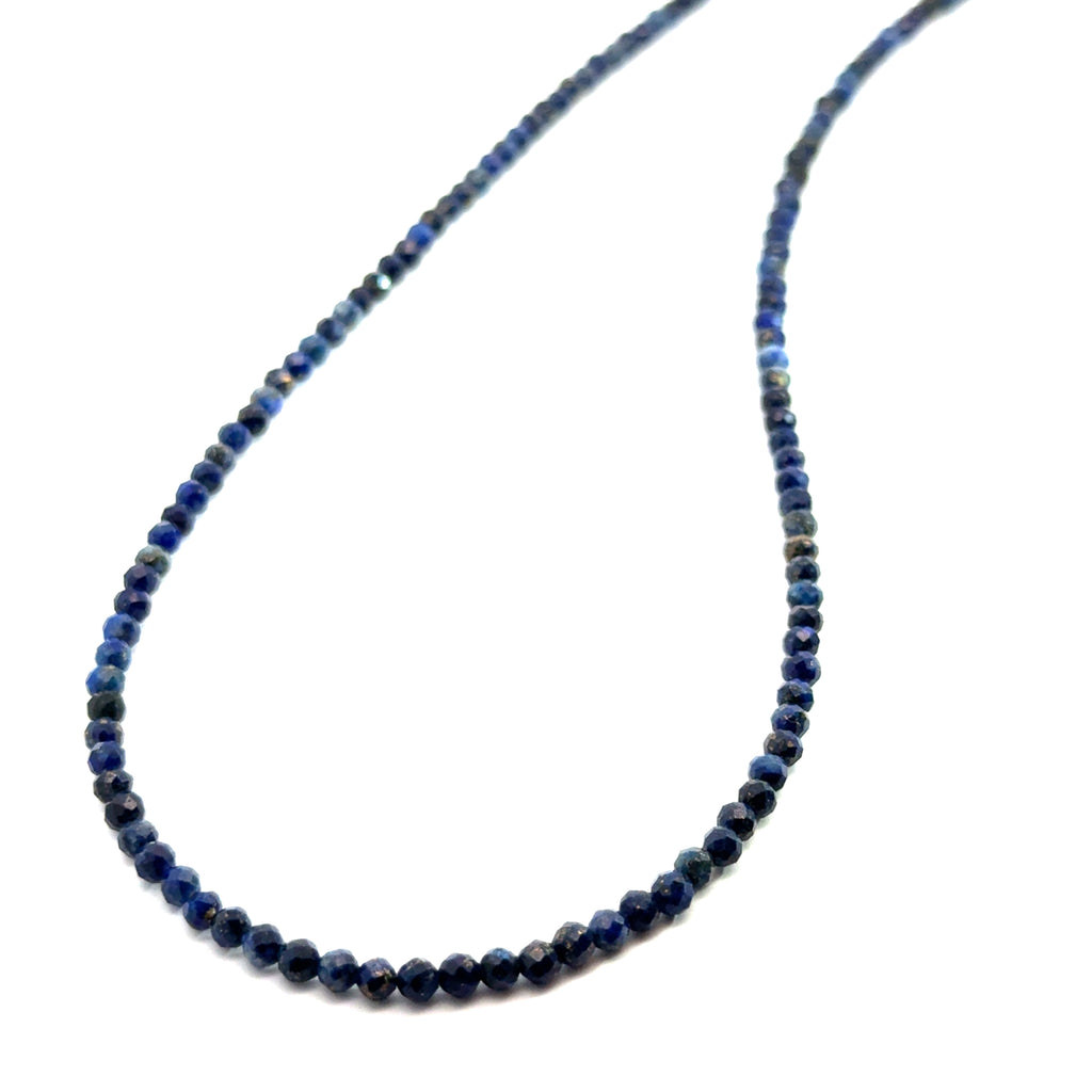 A Lapis Lazuli gemstone beaded necklace white background long overview, front, long, hanging slight angled overview.