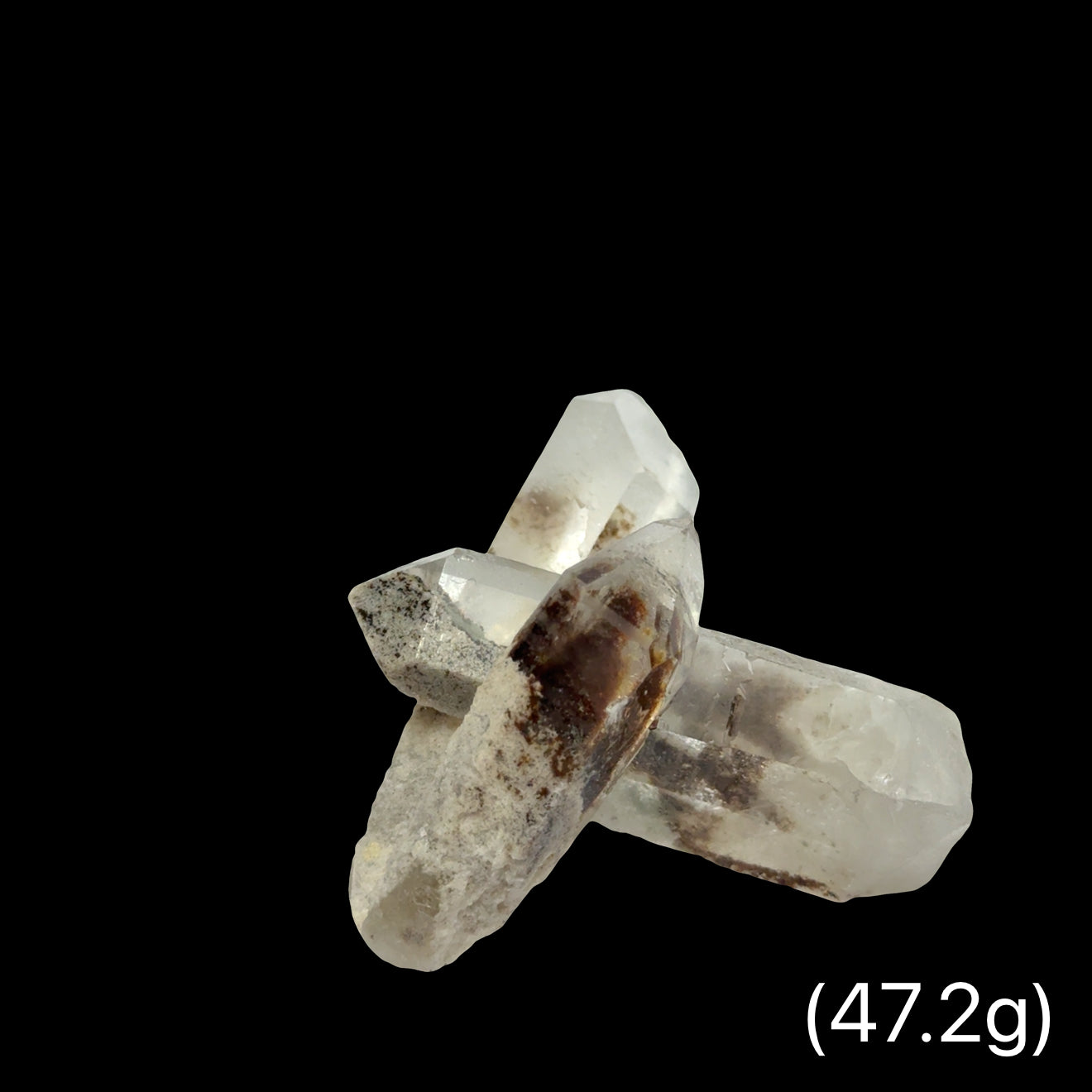 A Quartz crystals with phantoms and inclusions (47,2g) on a black background, front view.