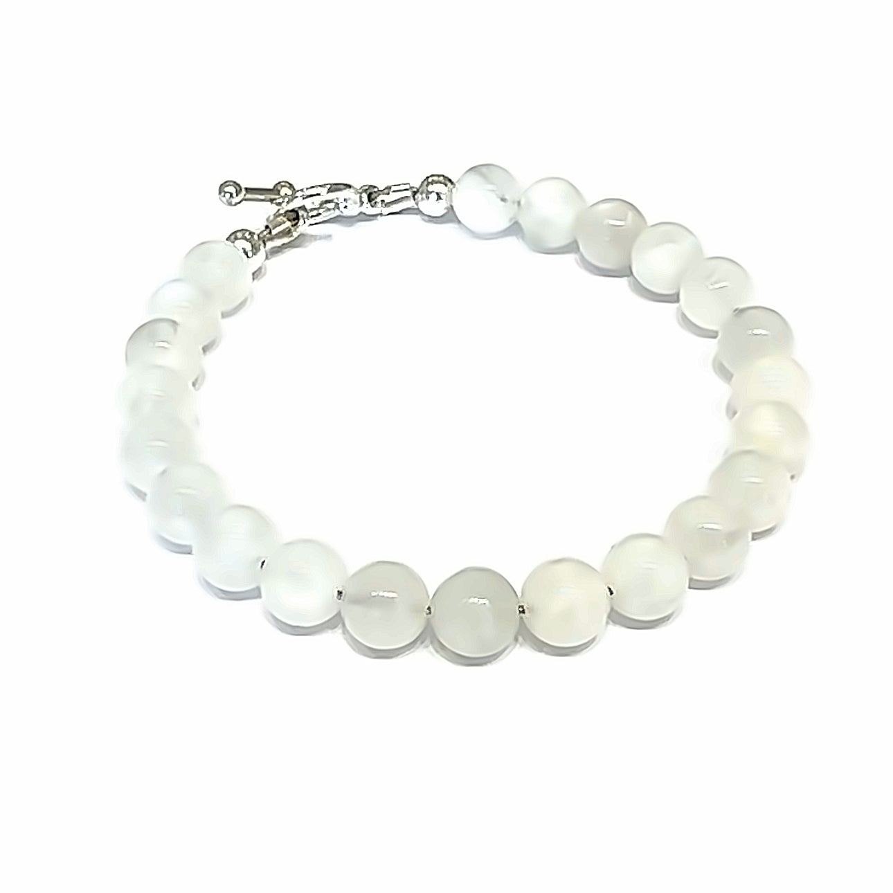 A Rainbow Moonstone beaded bracelet with a sterling silver toggle on a white background front left close up overview. 