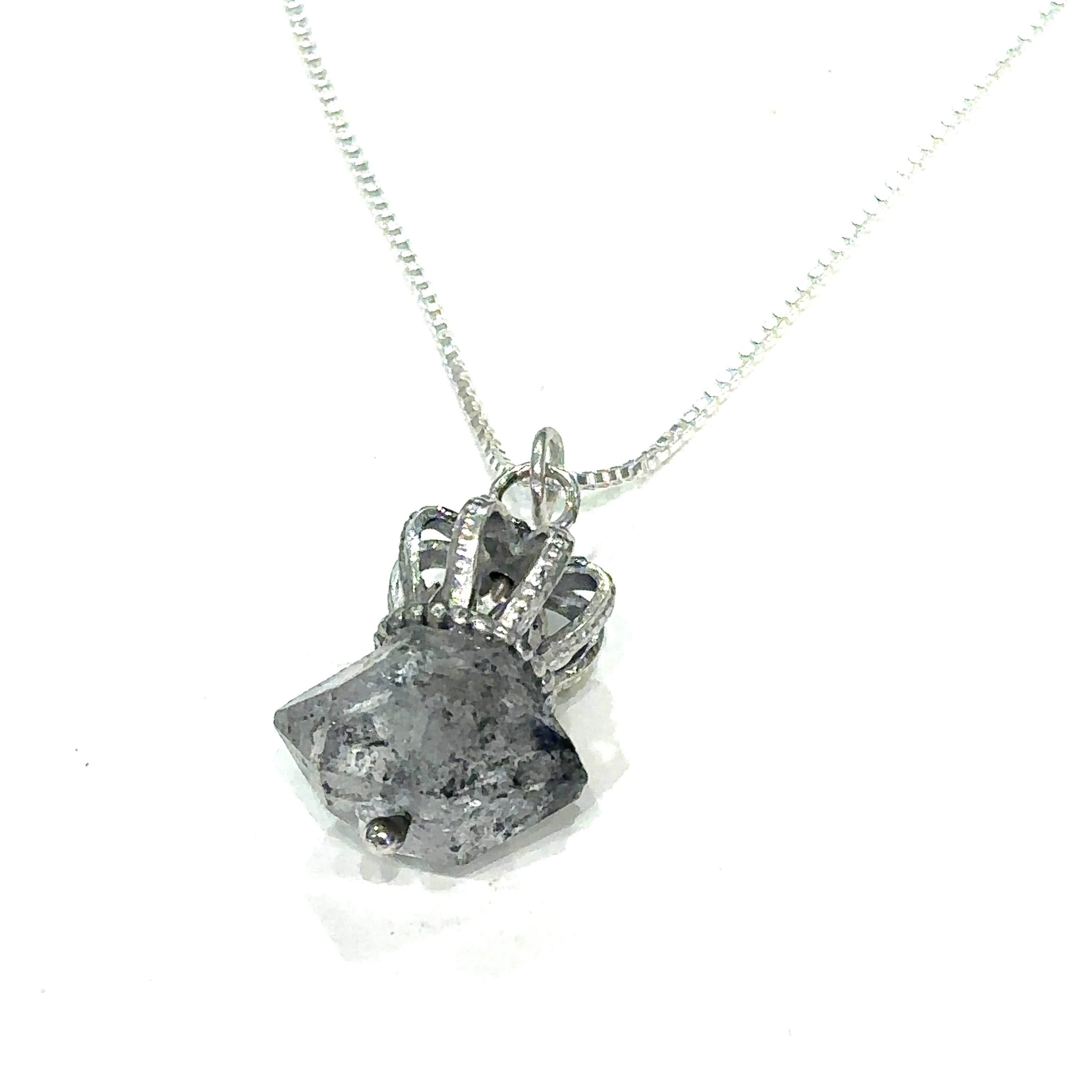 A Sterling Silver Crown Pendant with Herkimer Diamond  gemstone on a white background, hanging overview.  