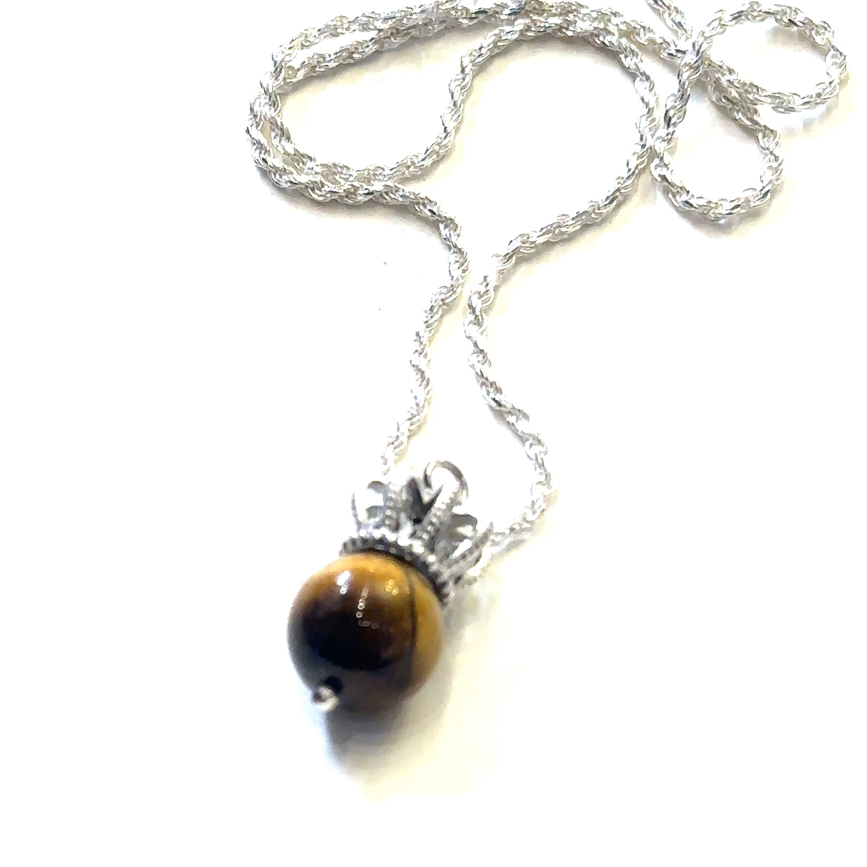 A Sterling Silver Crown Pendant with golden tiger eye gemstone on a white background, long, front overview.  