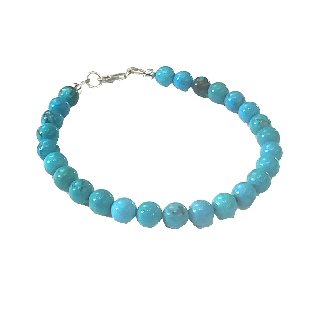 A  Top-grade Turquoise 6mm gemstone smooth beads strung on durable Beadalon wire with a sterling silver toggle on a white background  front center view.