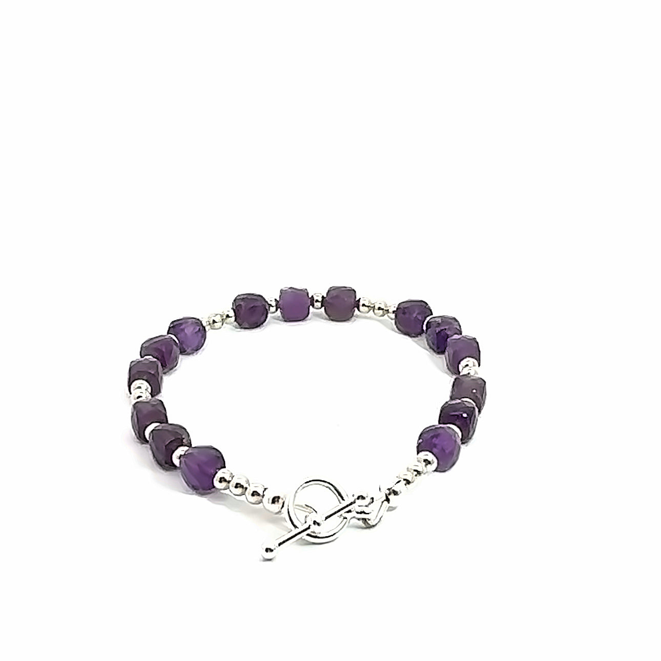 A beaded Amethyst faceted cube gemstone bracelets with a sterling silver beads and  toggle, displayed against a white background, back overview. 