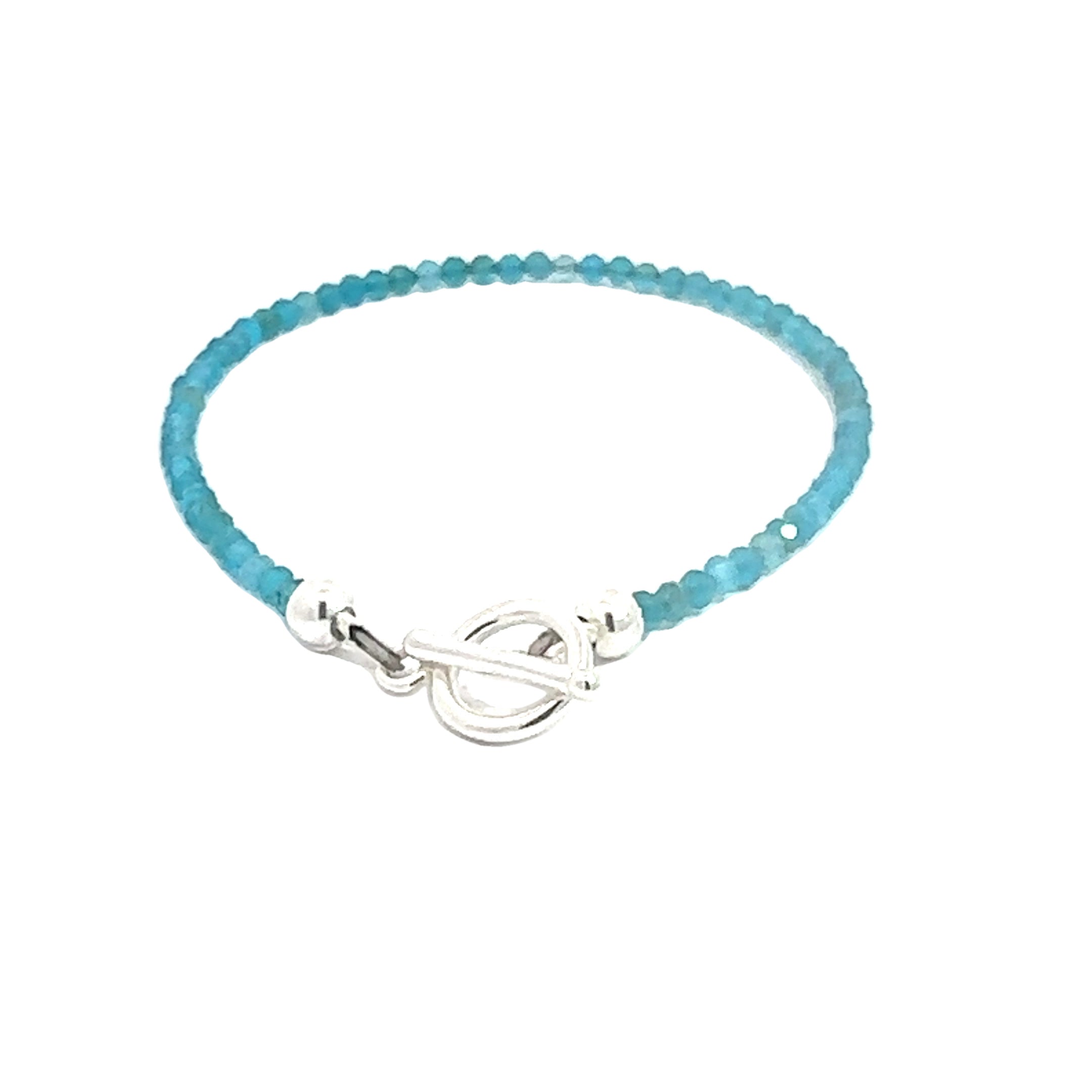 A blue Apatite 2mm faceted beaded gemstone bracelet with sterling silver toggle, displayed against a white background, back overview.