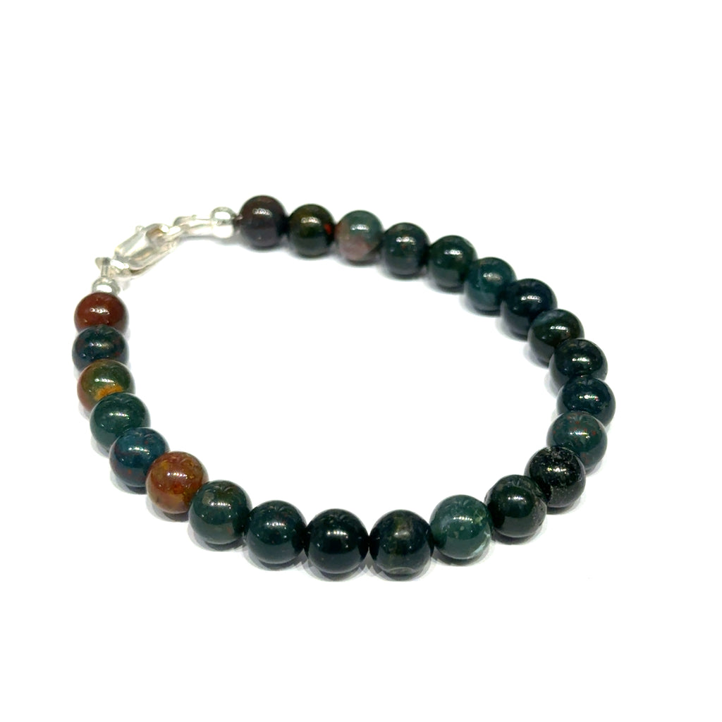 A close-up of polished bloodstone beaded gemstone bracelet  6mm size 6''  showing deep forest green jasper with natural red hematite inclusions on a white background, front right angle overview. 