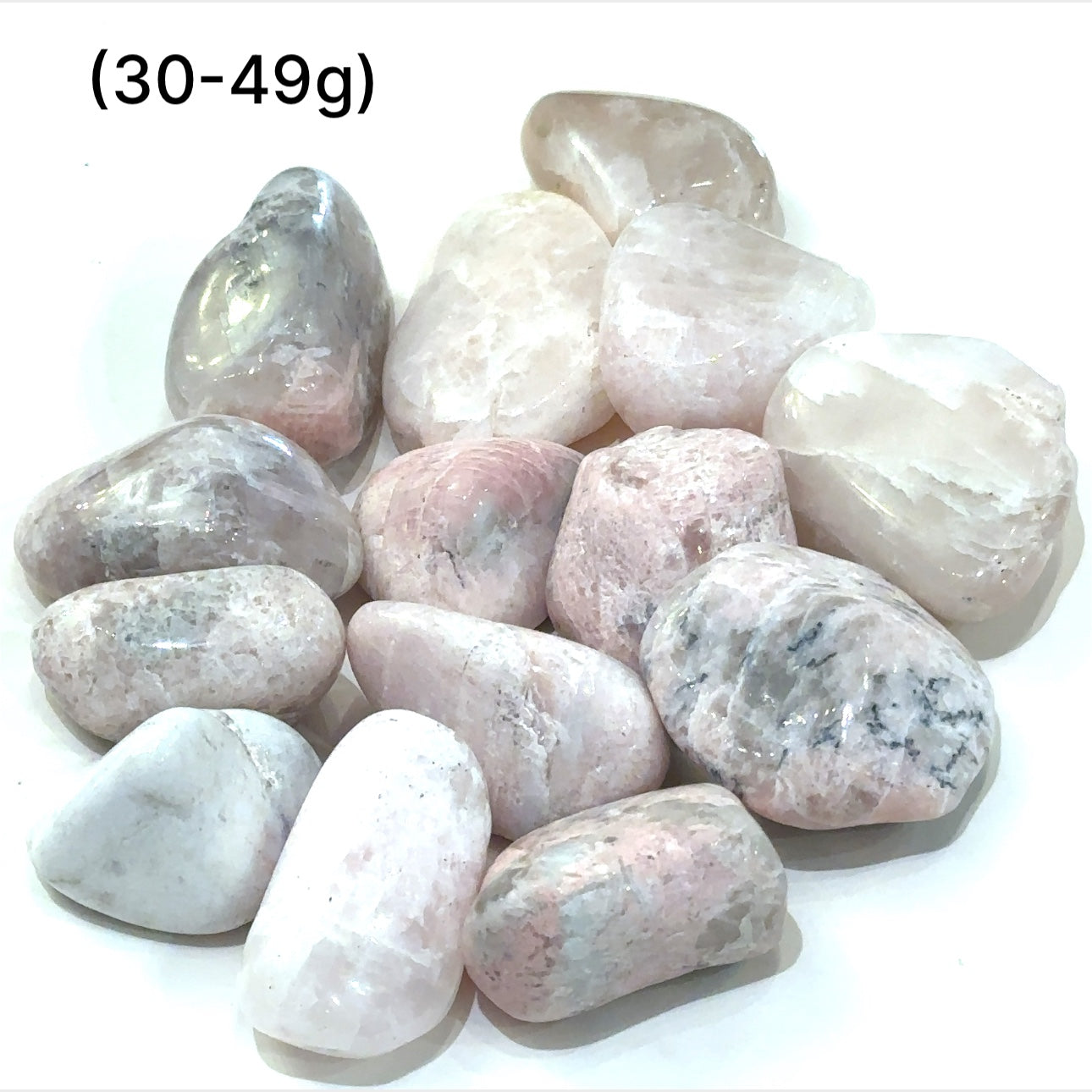 A collection of (30-49g) tumbled Petalite gemstones with a pink hue, displayed   on a white background, front overview.