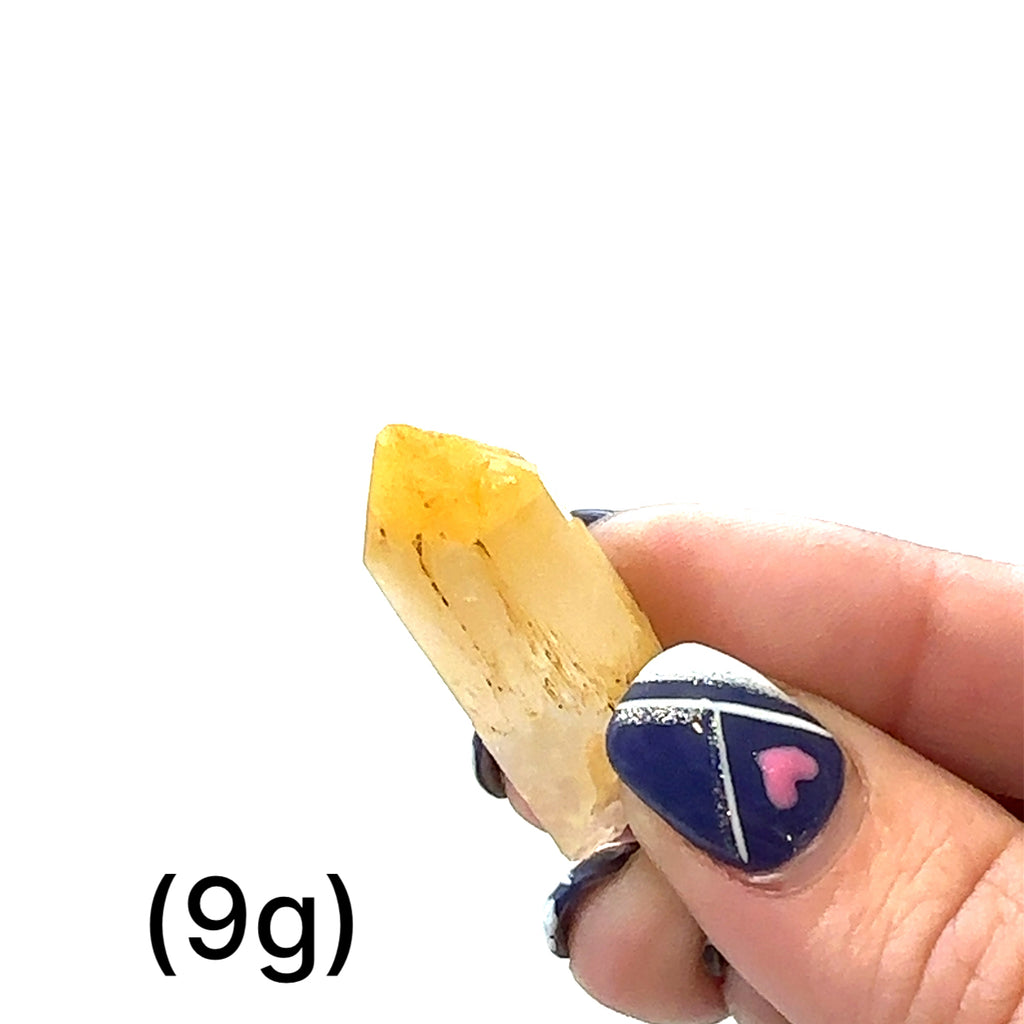 A collection of Halloysite-Included Quartz gemstones, also known as 'Mango Quartz', sizes (9g) is displayed on a white surface center overview.