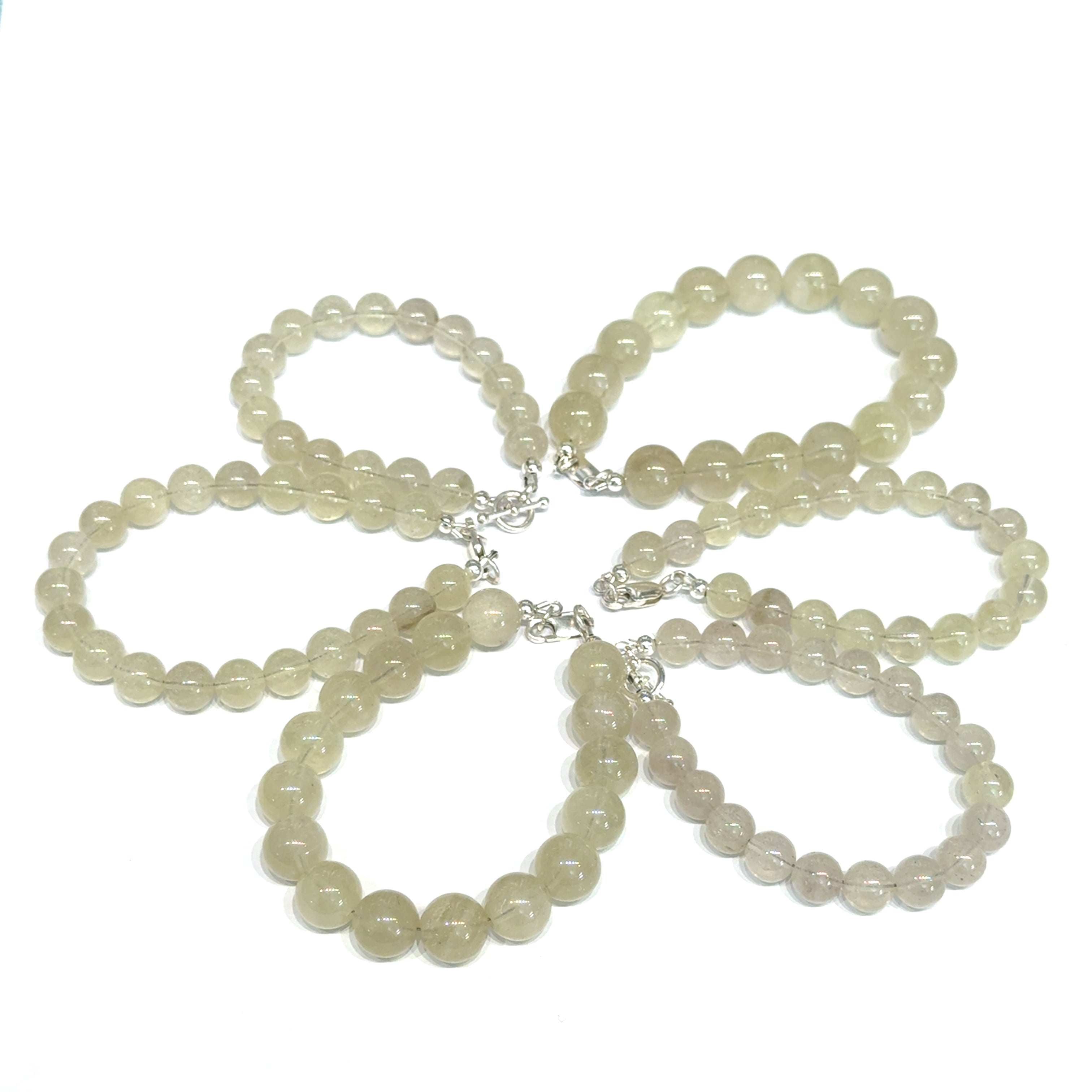 A collection of Libyan Desert Glass bracelet with golden honey beads and sterling silver clasp for manifestation and cosmic connection on a white background, front overview. 
