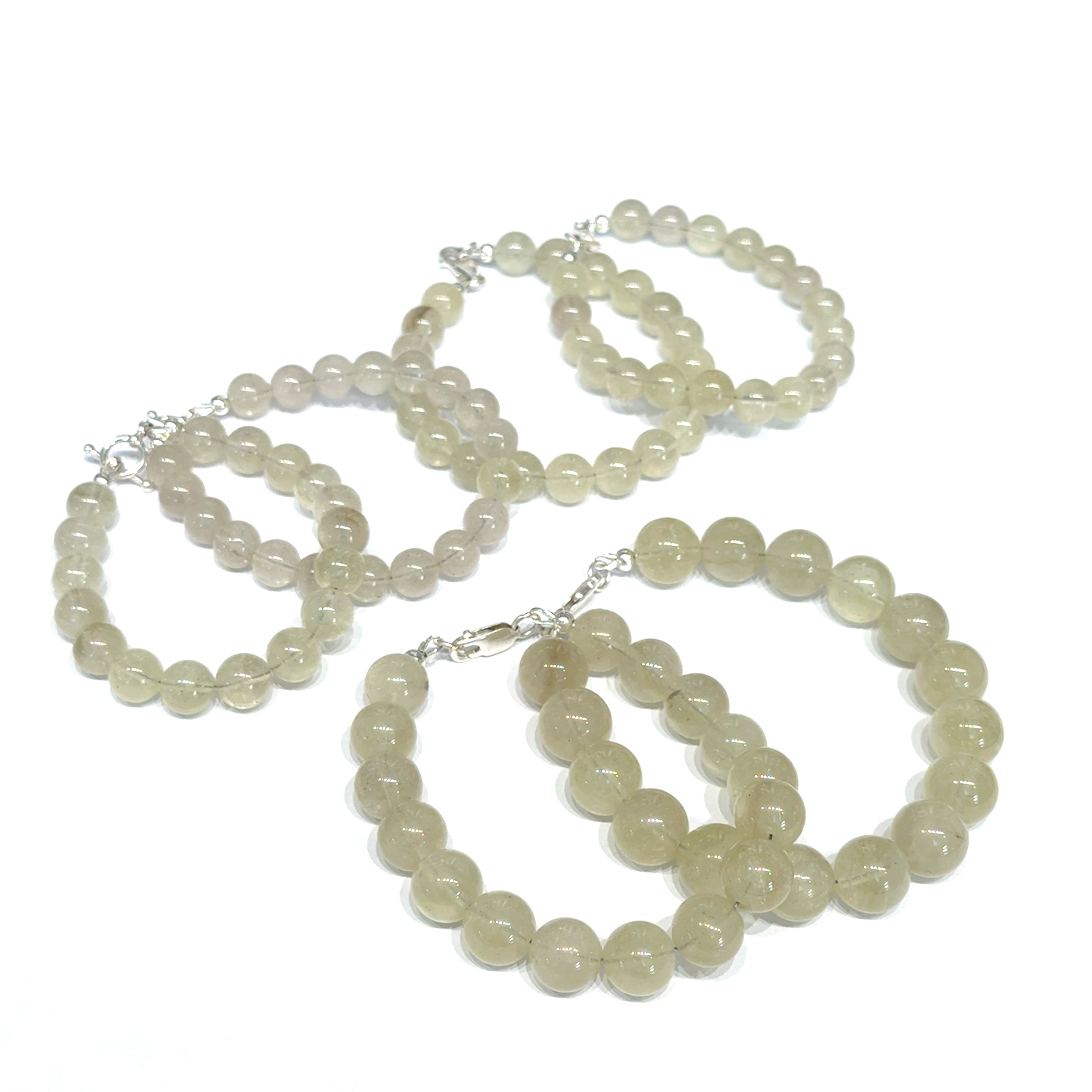 A collection of Libyan Desert Glass bracelet with golden honey beads and sterling silver clasp for manifestation and cosmic connection on a white background, front view. 