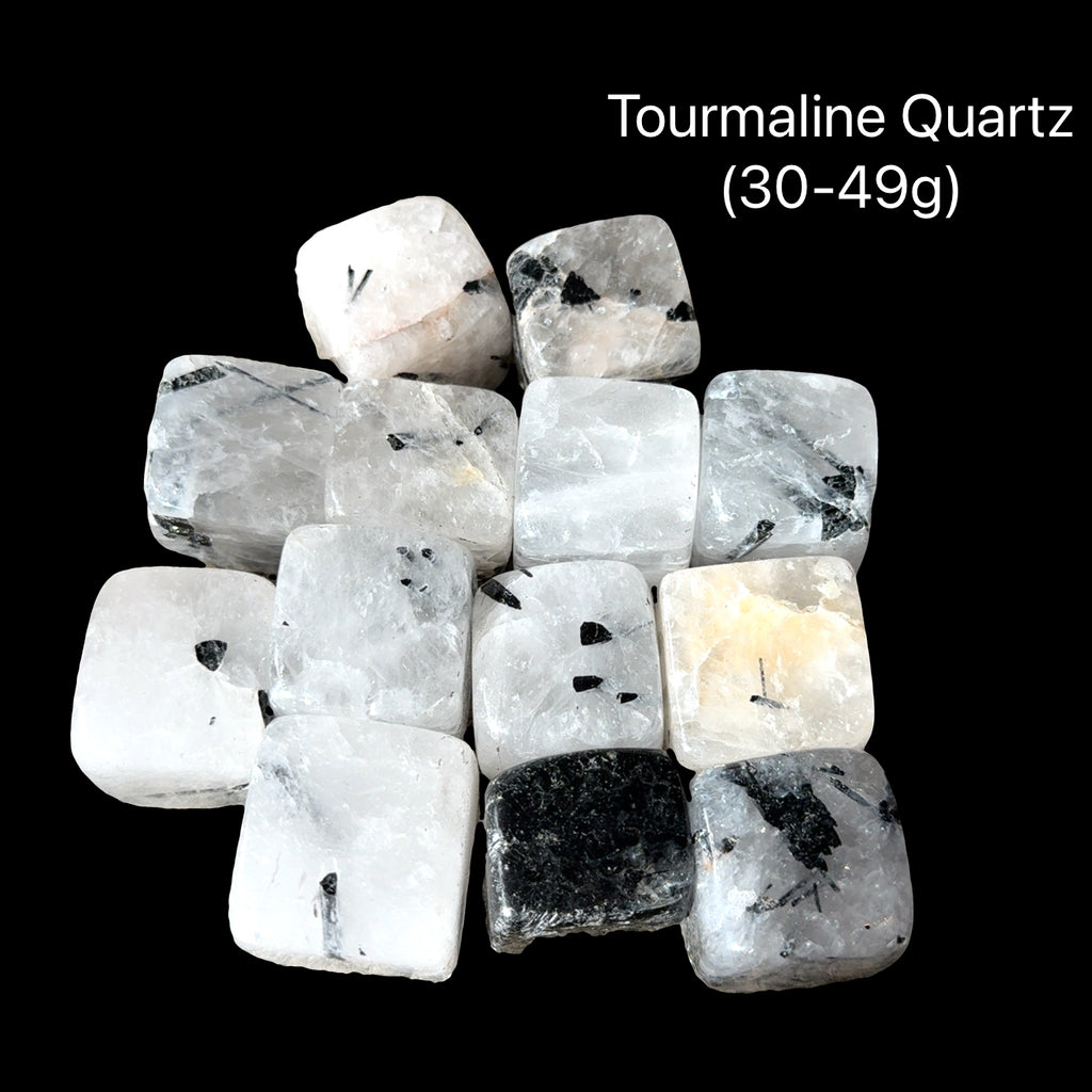 A collection of Tourmalinated Quartz tumbled gemstones displayed on a Black background, (30-49g) weight range, front overview.
