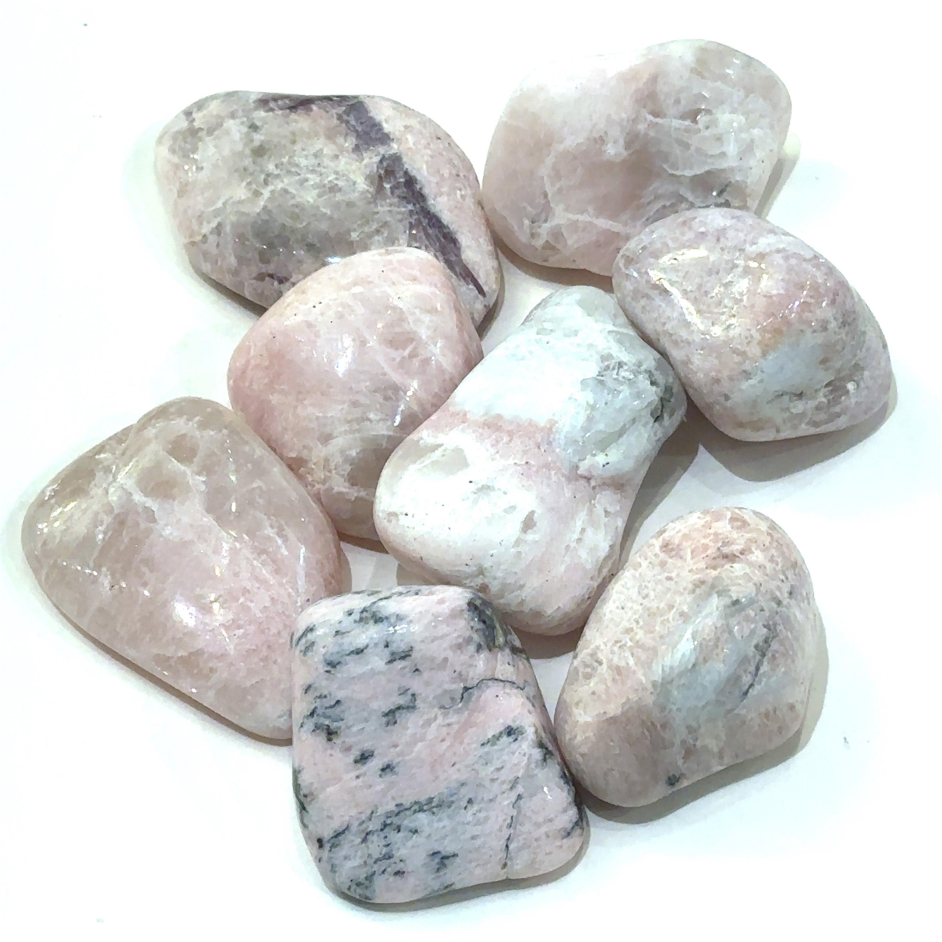 A collection of med tumbled Petalite gemstones with a pink hue, displayed   on a white background, front overview.