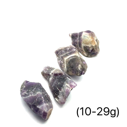 A collection of raw Amethyst or Prasiolite gemstones size (10-29g) on a white background, front view.