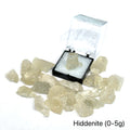 A collection of raw Hiddenite gemstones displayed on a white surface. (0-5g) front overview.