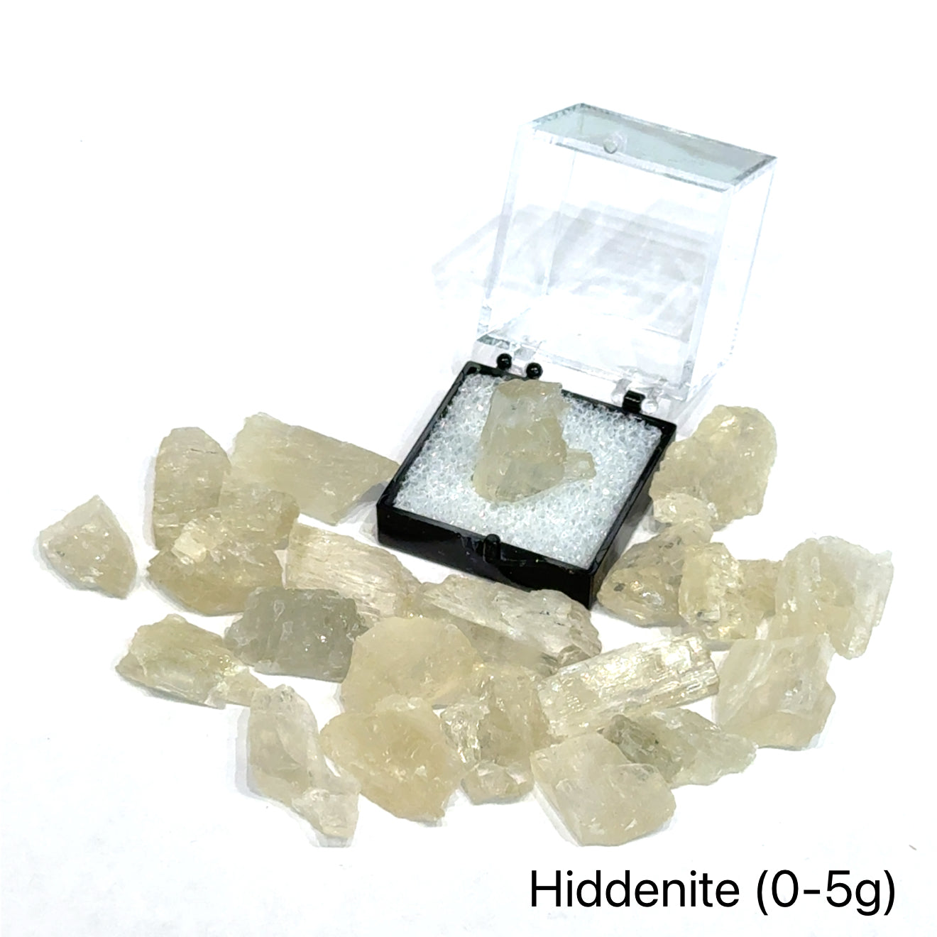 A collection of raw Hiddenite gemstones displayed on a white surface. (0-5g) front overview.