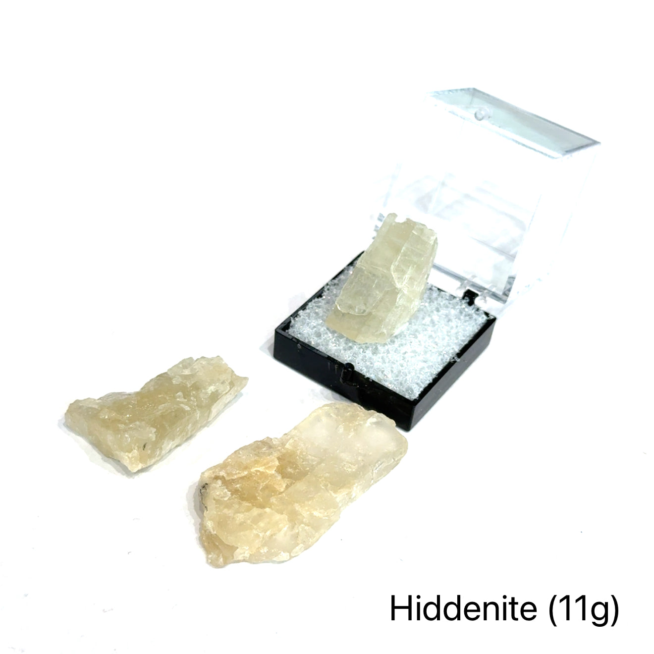 A collection of raw Hiddenite gemstones displayed on a white surface. (11g) front overview.