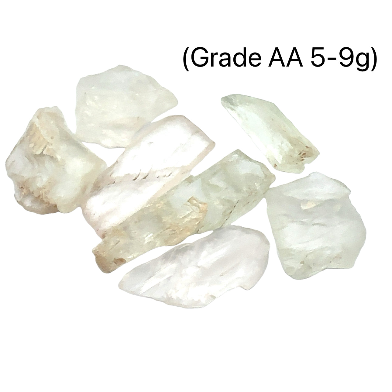 A collection of raw Hiddenite gemstones displayed on a white surface. (grade AA 5-9g) front overview. 
