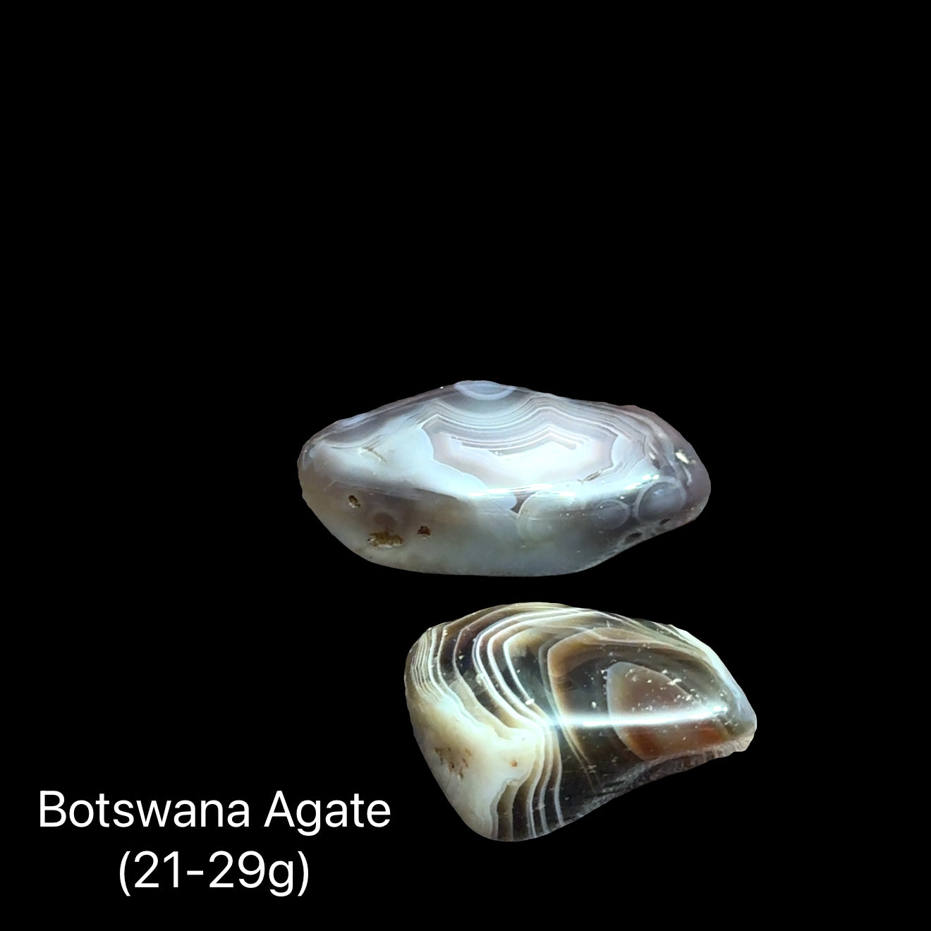 A collection of tumbled Botswana Agate gemstones on a Black background, (21-29g) front view.