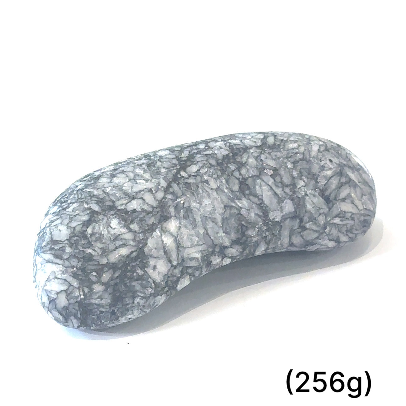 A collection of tumbled Pinolith gemstones (256g) displayed on a white background, with varying shades of gray and white patterns.