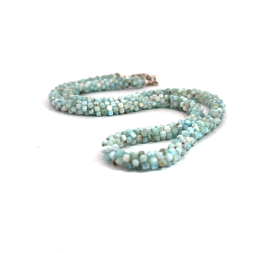 A crocheted necklace made with Larimar gemstone beads and a sterling silver butterfly box clasp on a white background, front close up overview. 