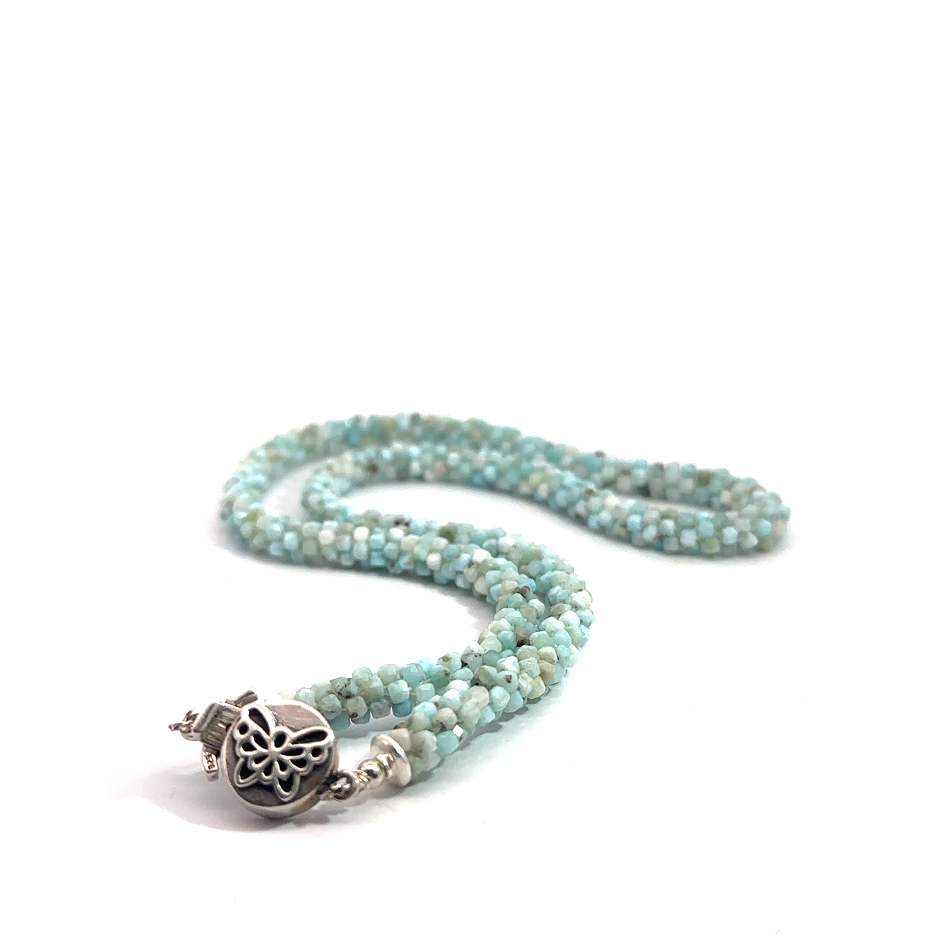 A crocheted necklace made with Larimar gemstone beads and a sterling silver butterfly box clasp on a white background, long box clasp view. 
