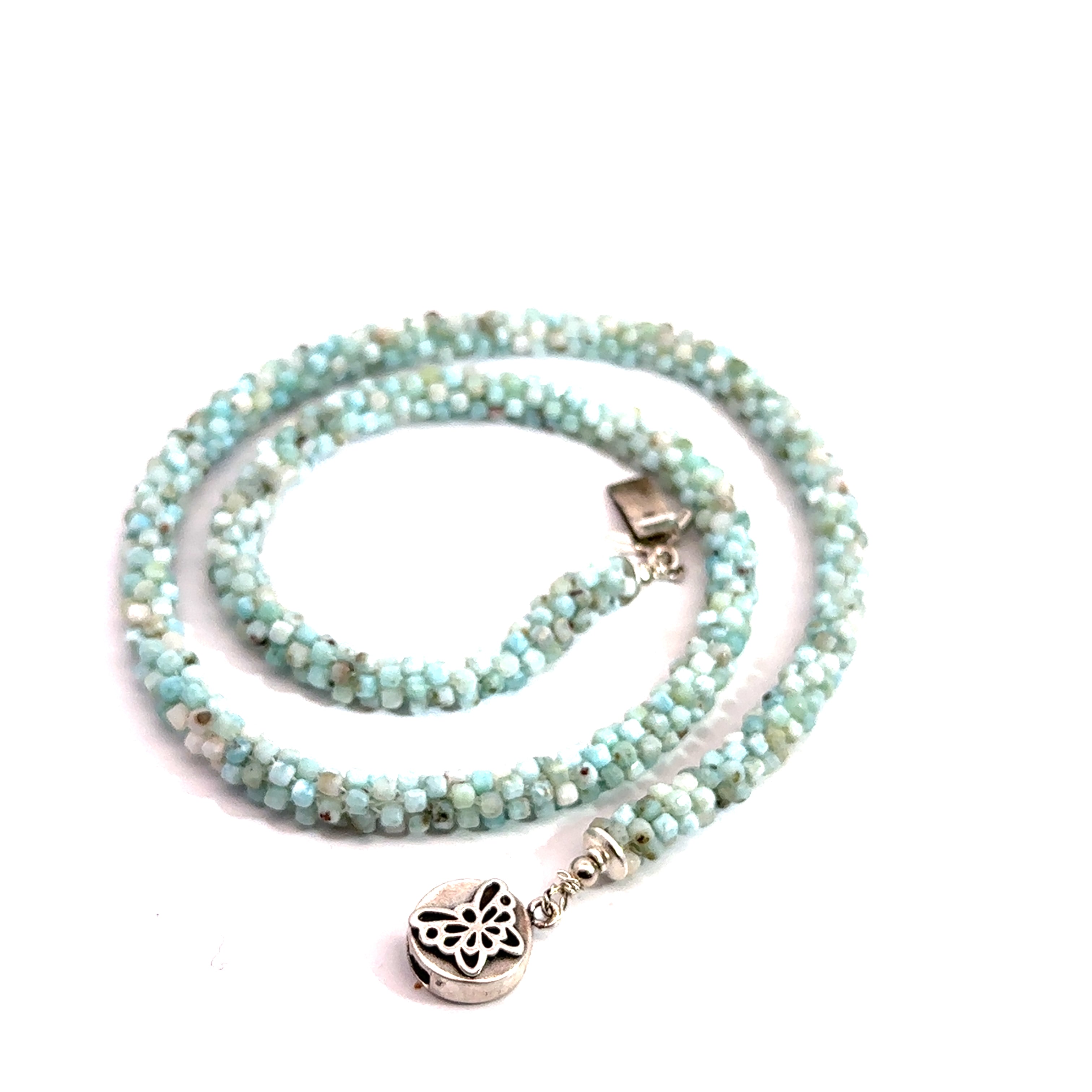 A crocheted necklace made with Larimar gemstone beads and a sterling silver butterfly box clasp on a white background, spiral box clasp overview. 