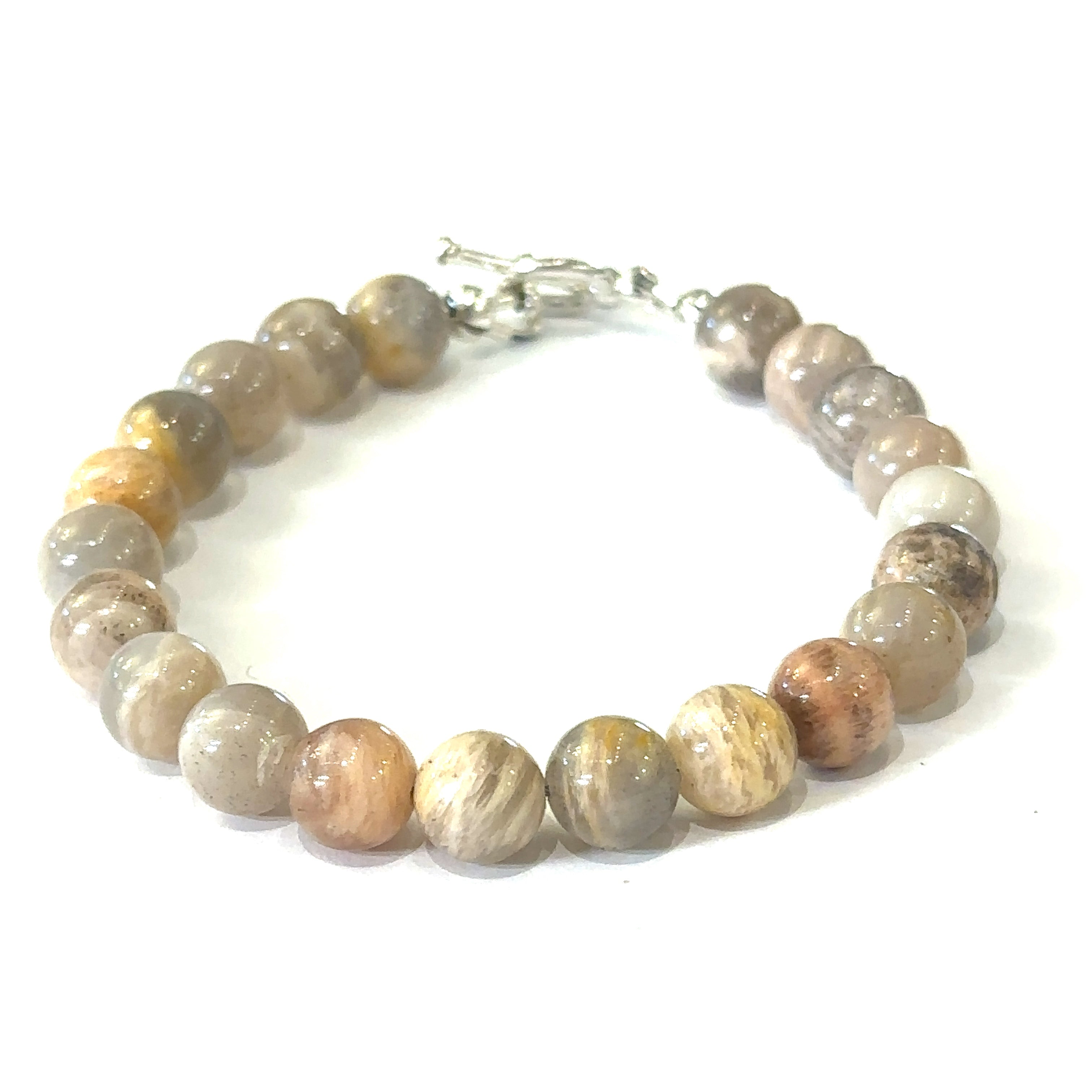A greyish peach Moonstone gemstone beaded bracelet with a sterling silver toggle clasp on a white background, front overview. 
